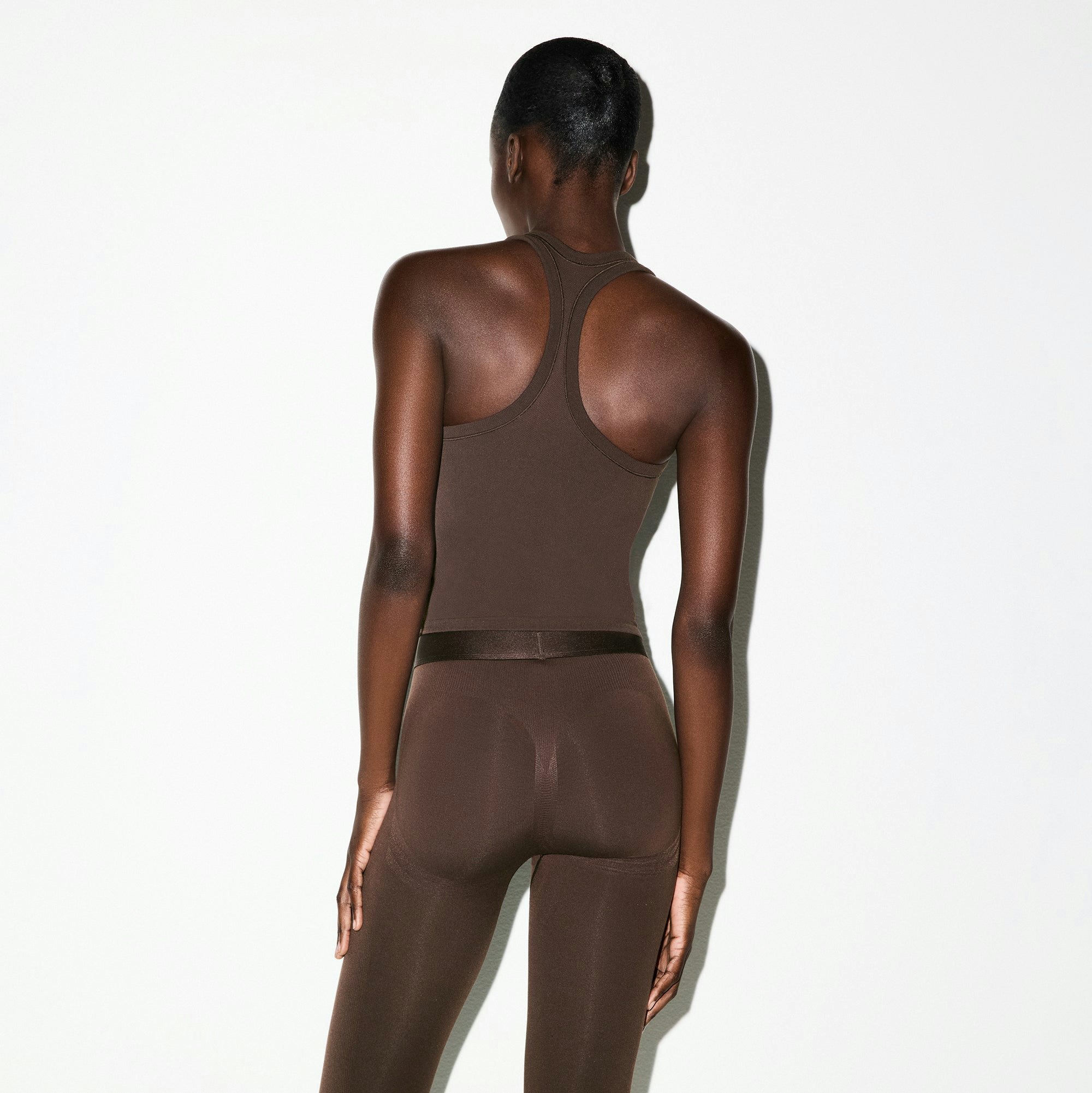 NikeSKIMS VINTAGE SEAMLESS RACER BACK TANK | PHOENIX ON A MODEL SIDE VIEW @ | FOCUS: 0.0, 1.0, 0.9