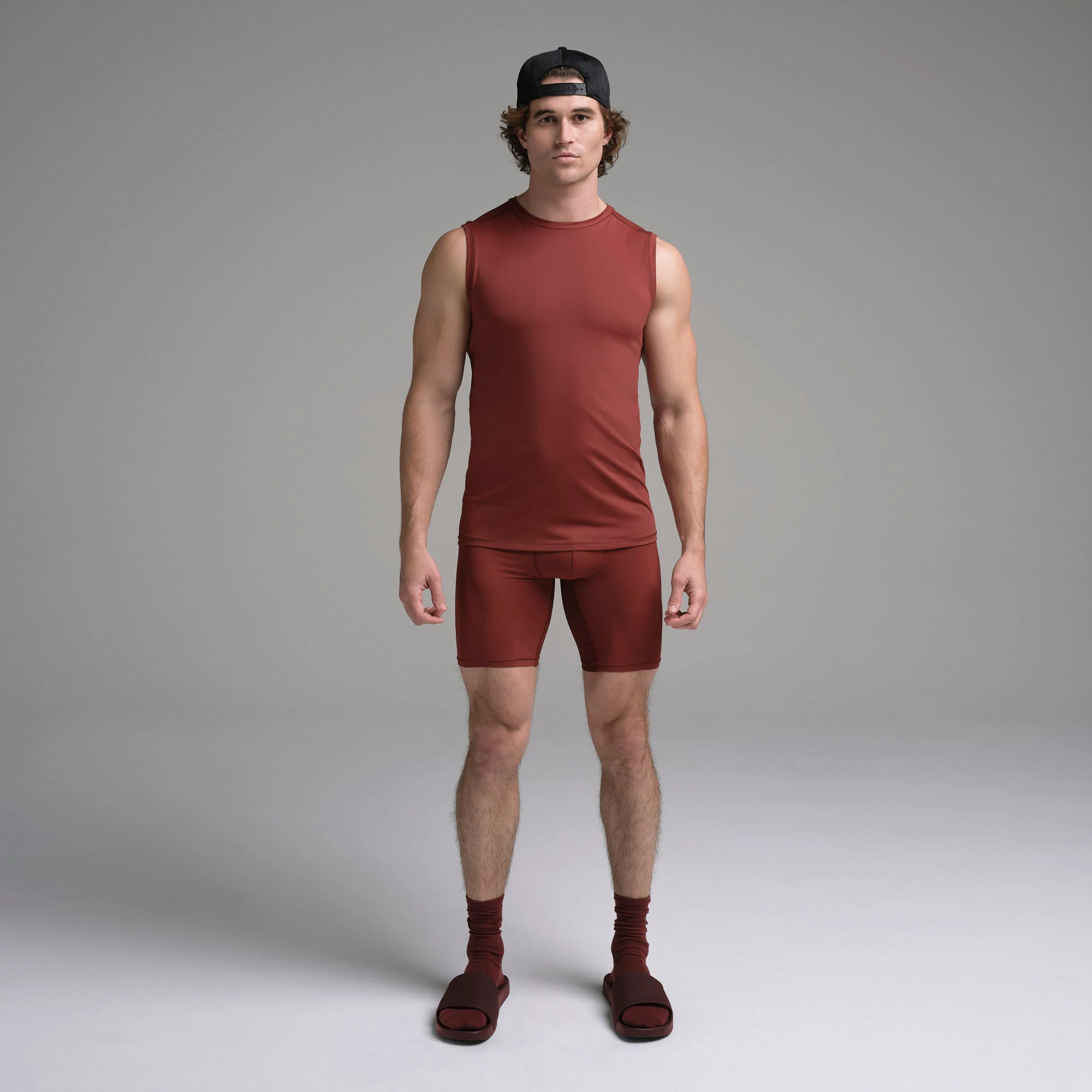 SKIMS SPORT MENS MUSCLE TANK | SANGRIA ON A MODEL FRONT VIEW | FOCUS: 0.0, 1.0, 0.9