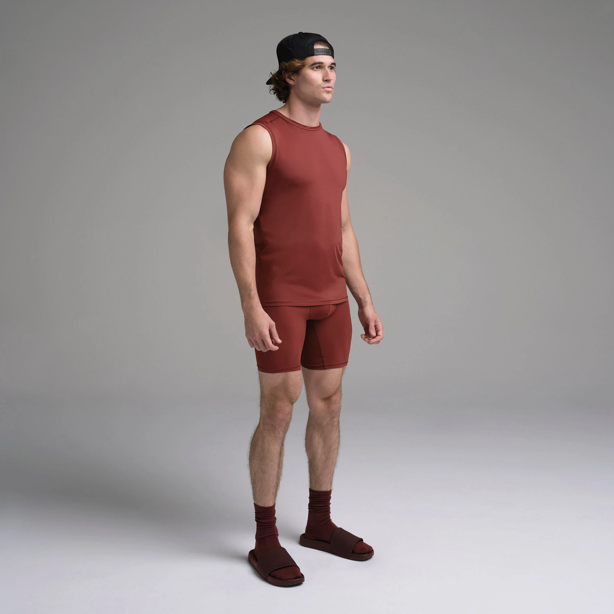 SKIMS SPORT MENS MUSCLE TANK | SANGRIA ON A MODEL SIDE VIEW | FOCUS: 0.0, 1.0, 0.9