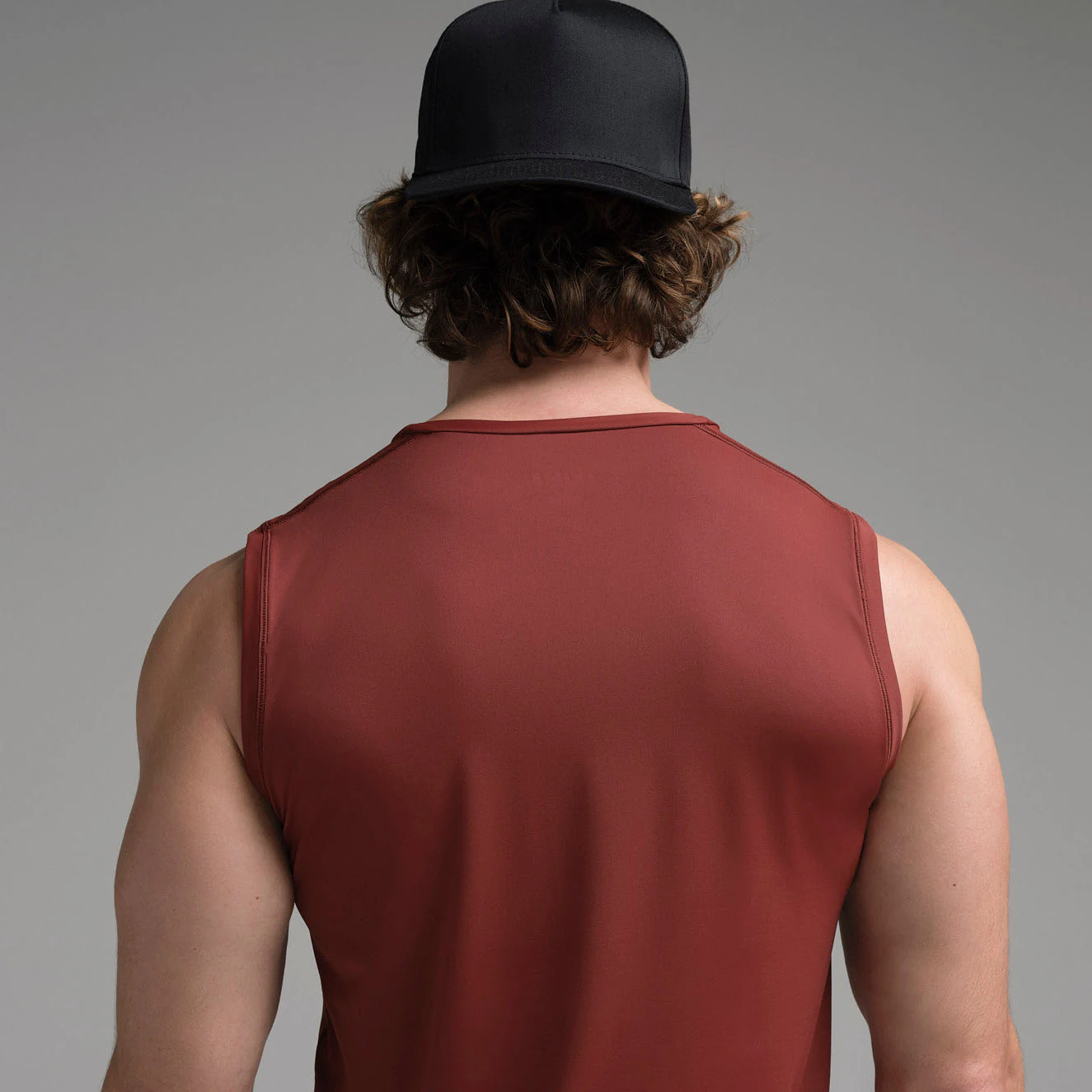 SKIMS SPORT MENS MUSCLE TANK | SANGRIA ON A MODEL SIDE VIEW | FOCUS: 0.0, 1.0, 0.9