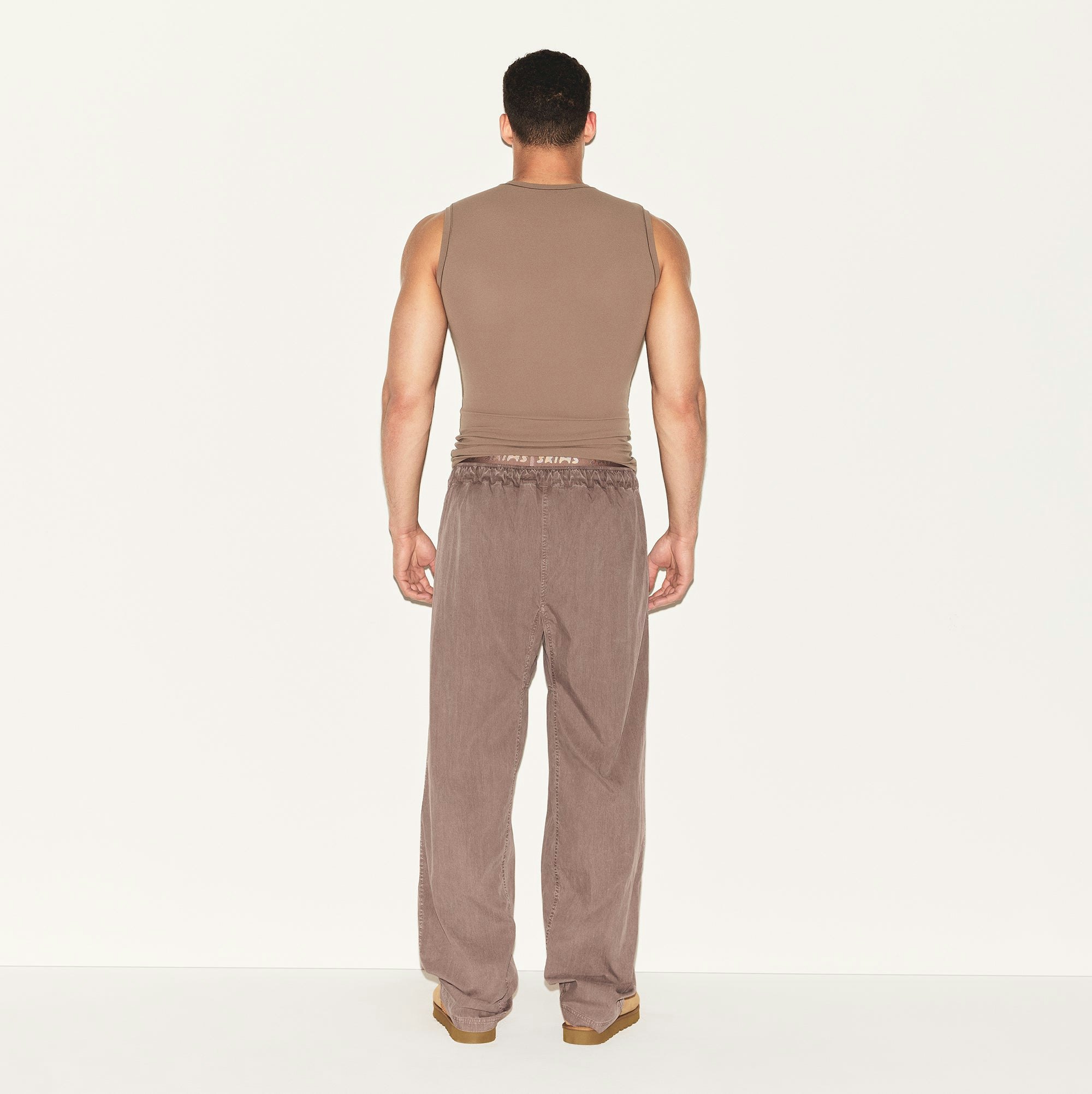 FITS EVERYBODY MENS SLIM TANK | UMBER ON A MODEL BACK VIEW | FOCUS: 0.0, 1.0, 0.9