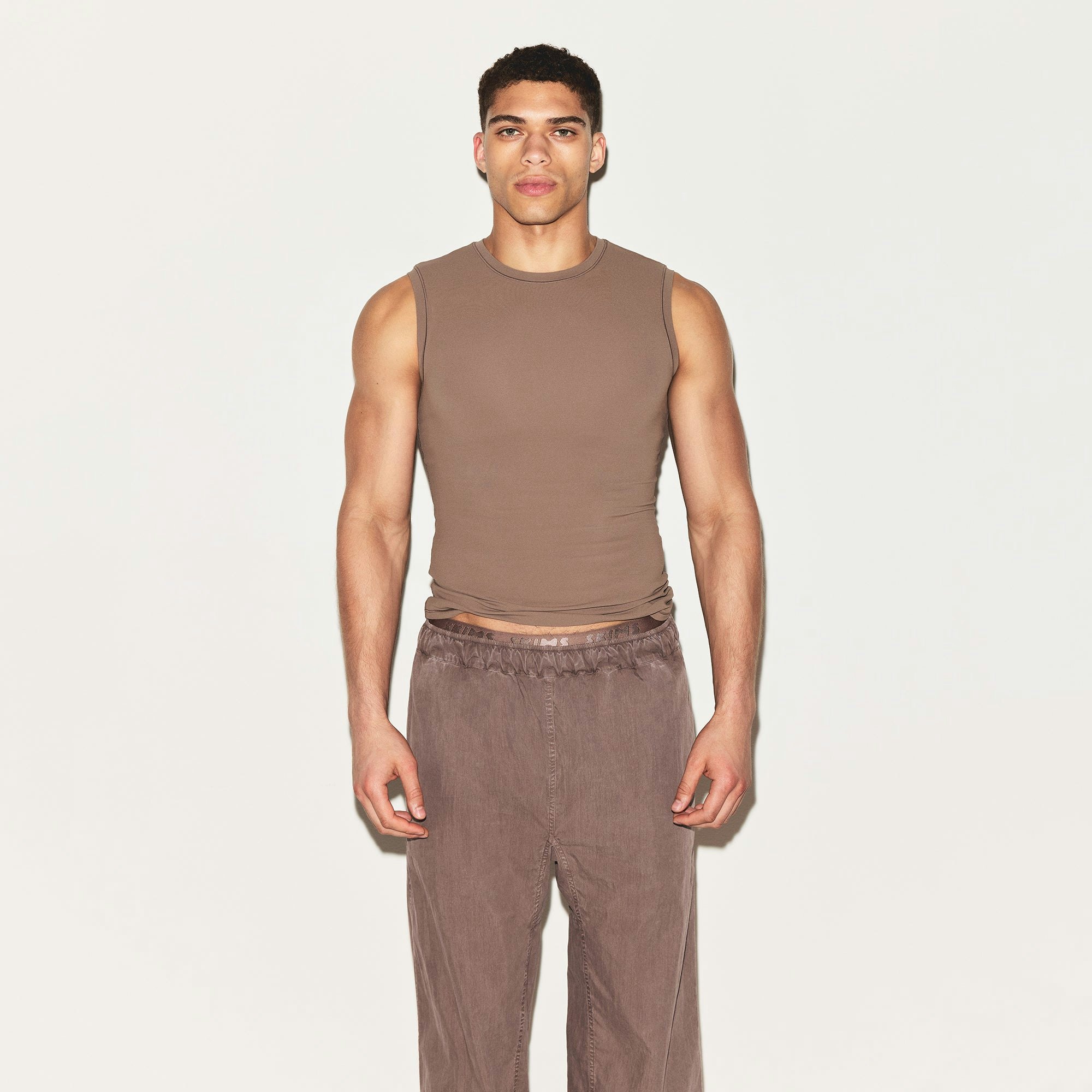 FITS EVERYBODY MENS SLIM TANK | UMBER ON A MODEL FRONT VIEW | FOCUS: 0.0, 1.0, 0.9