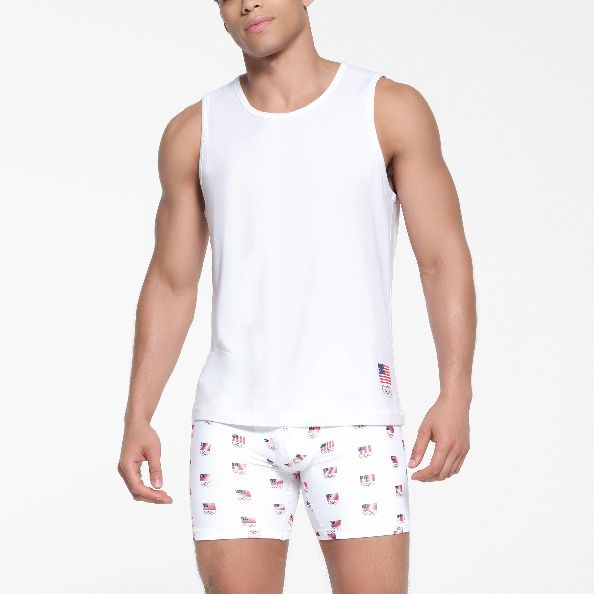SKIMS FOR TEAM USA SKIMS COTTON MENS OLYMPIC TANK | WHITE ON A MODEL FRONT VIEW