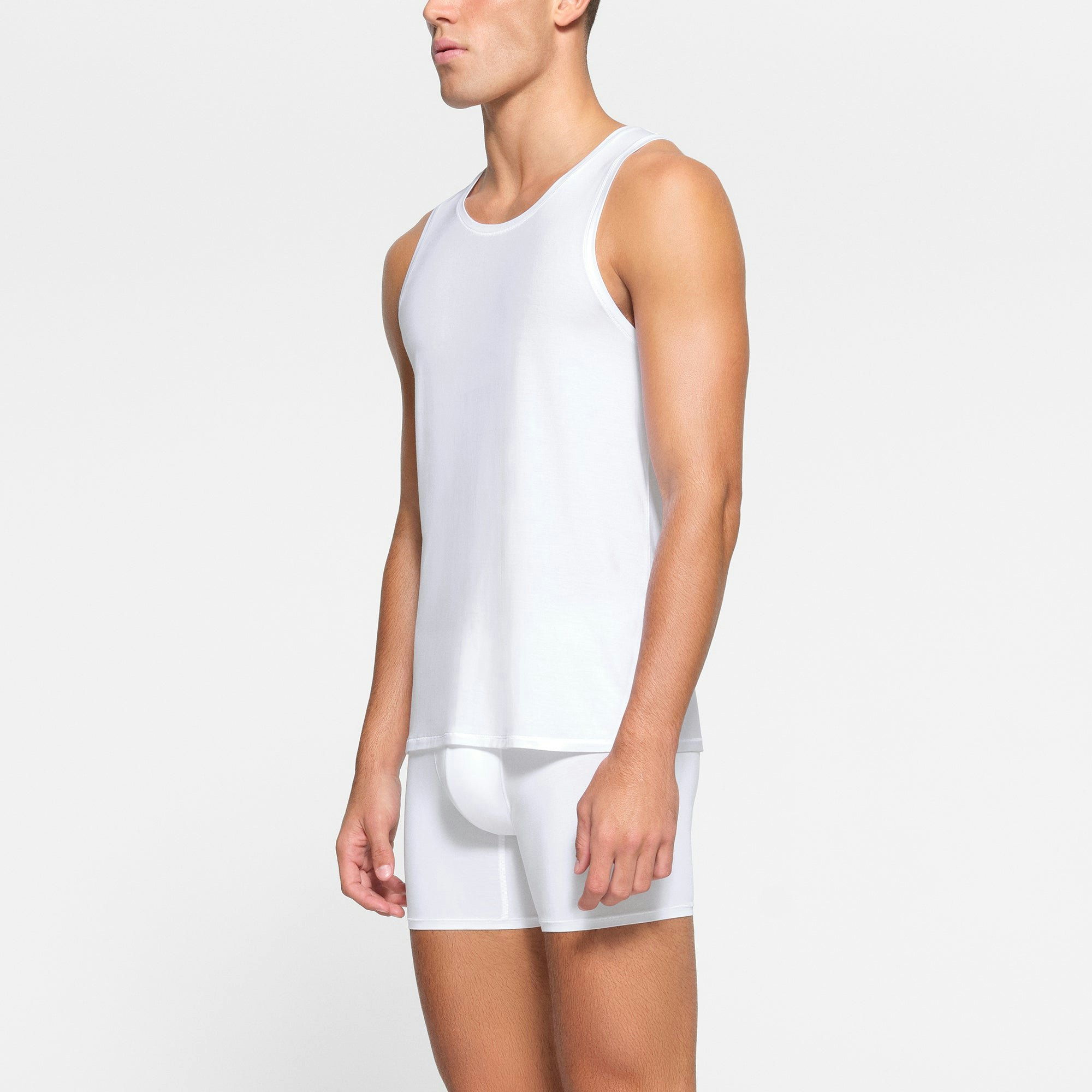 SKIMS STRETCH MENS TANK 3-PACK WORN BY A MODEL IN SIDE VIEW