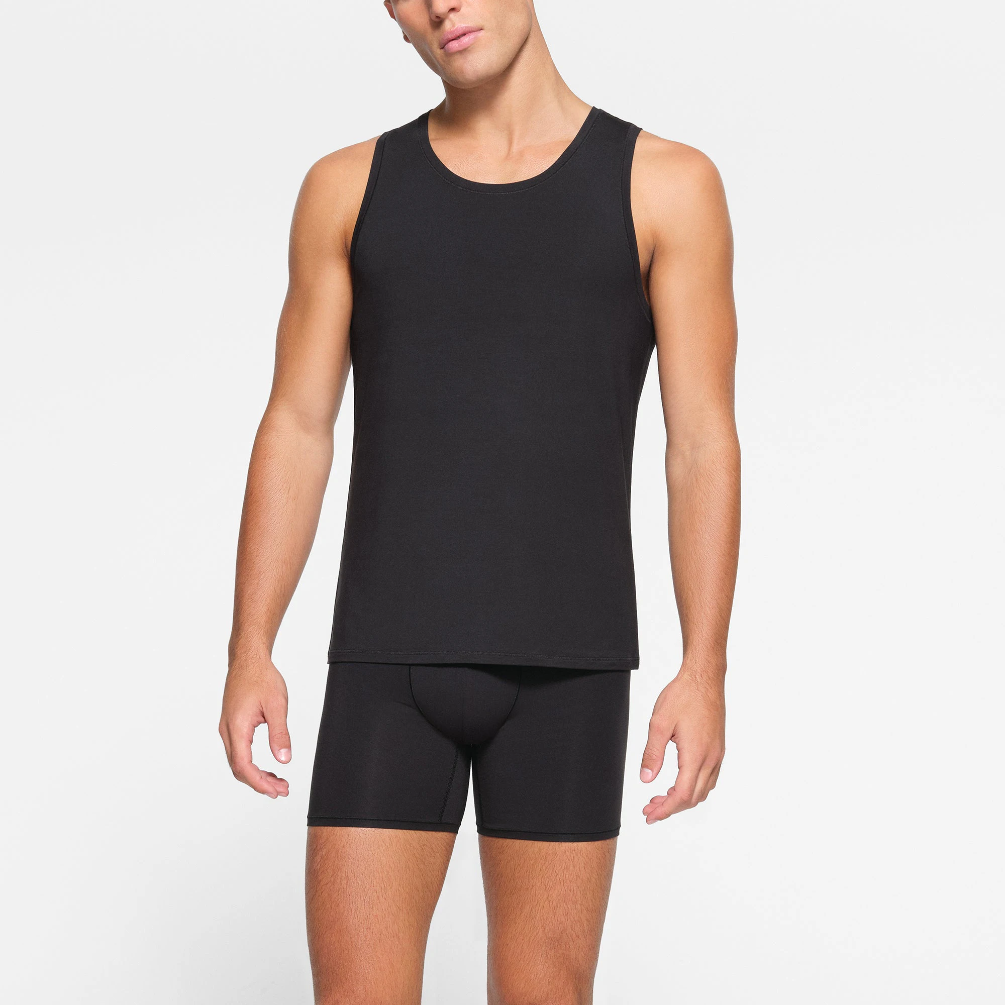 SKIMS STRETCH MENS TANK 3-PACK WORN BY A MODEL IN FRONT VIEW