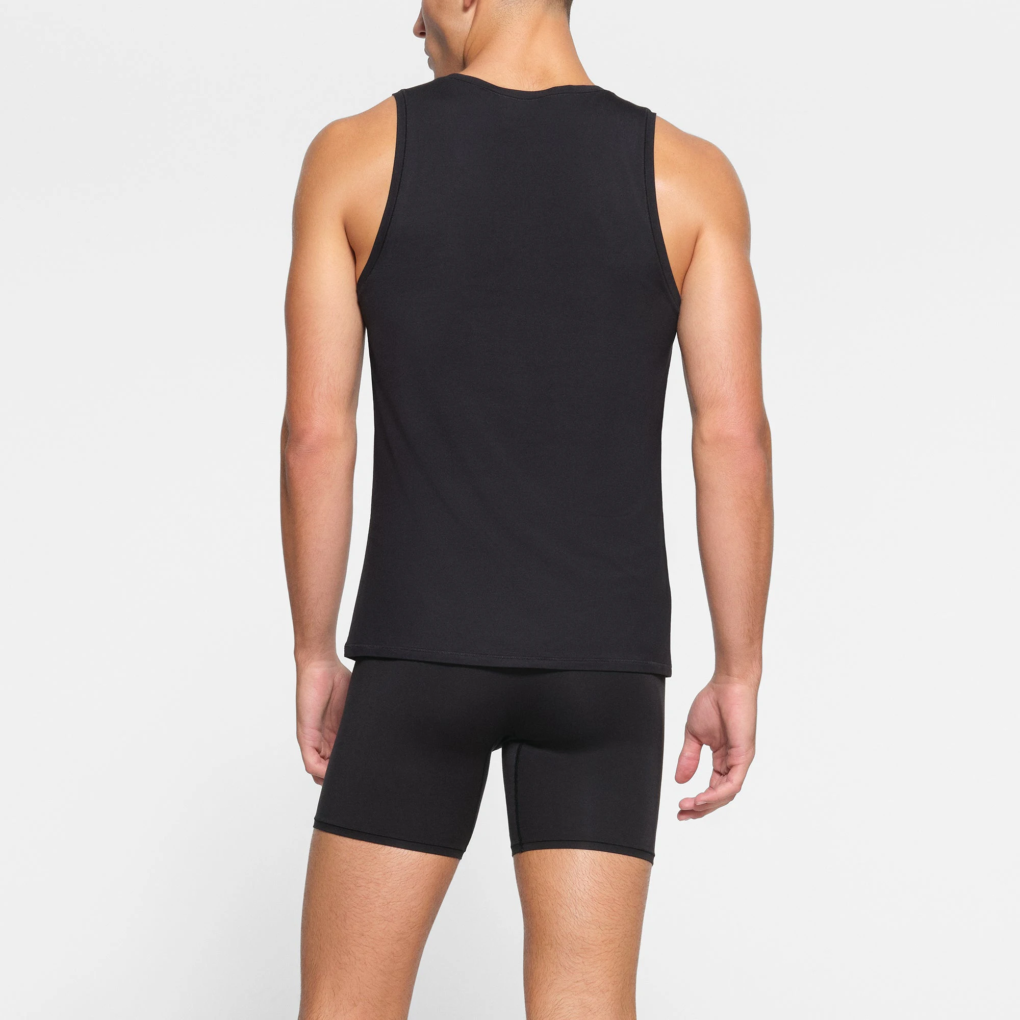 SKIMS STRETCH MENS TANK 3-PACK ON A MODEL BACK VIEW