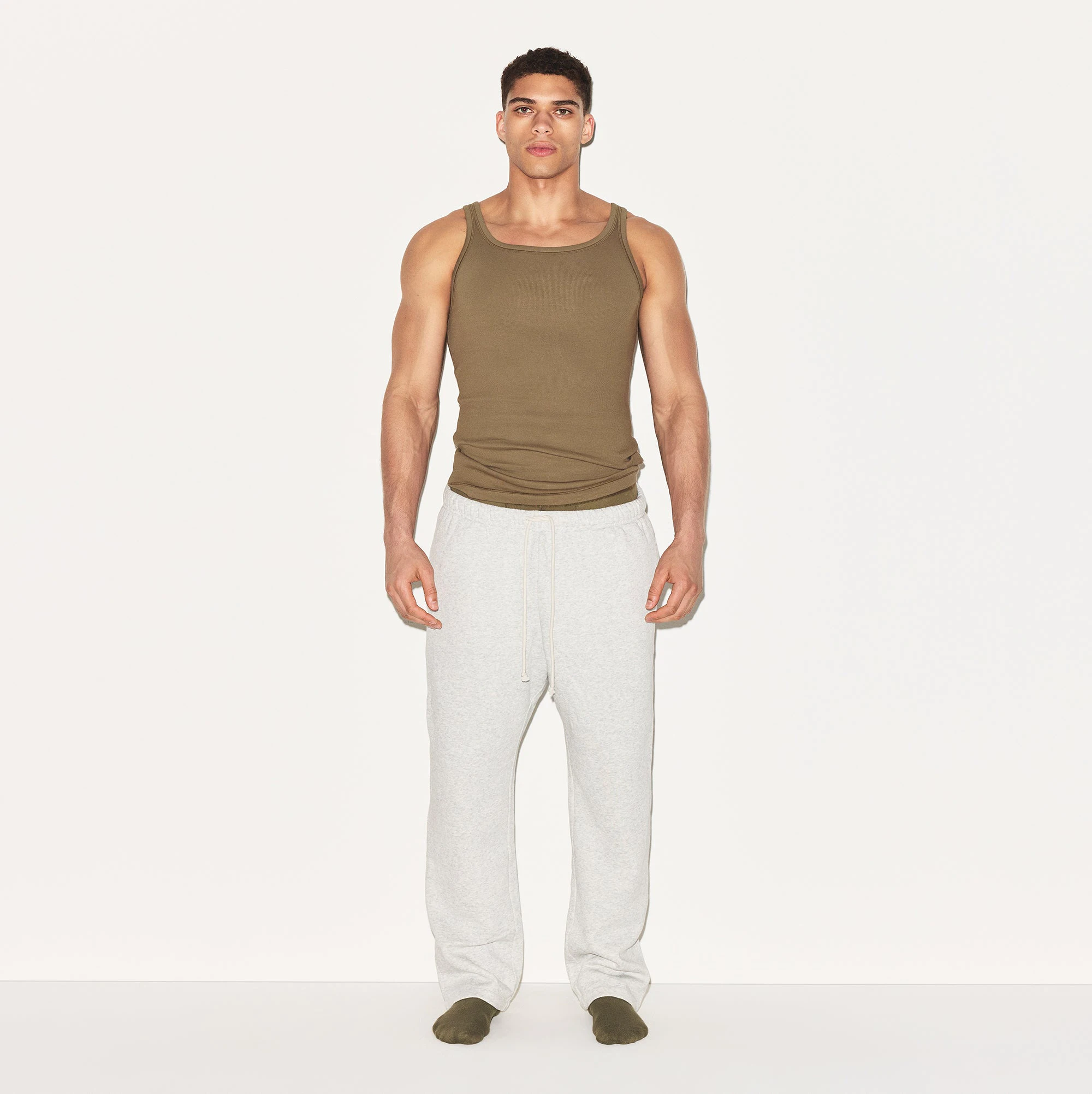 SKIMS COTTON MENS RIB TANK 3-PACK | ARMY MULTI ON A MODEL FRONT VIEW | FOCUS: 0.0, 1.0, 0.9