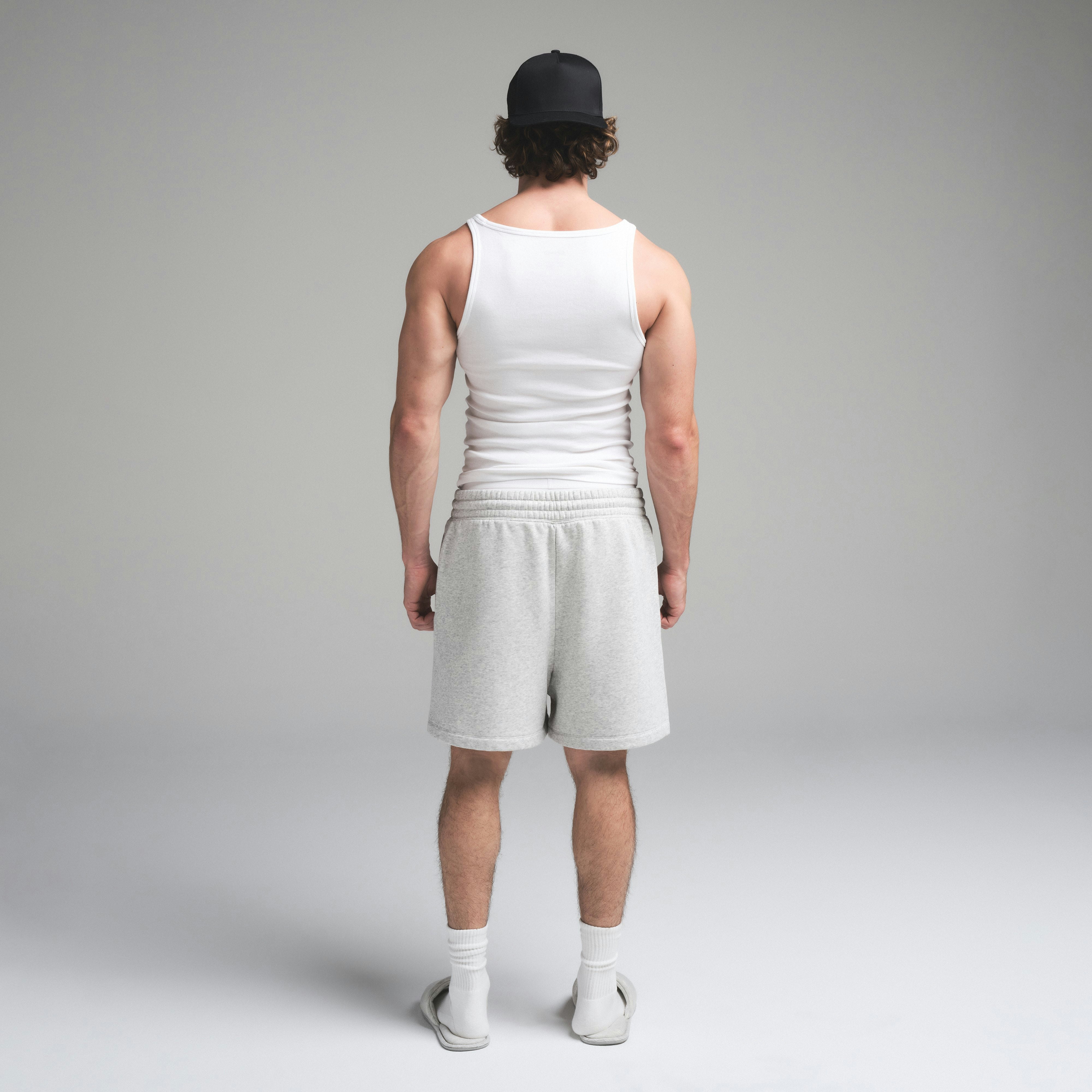 SKIMS COTTON MENS RIB TANK 3-PACK | CHALK ON A MODEL SIDE VIEW | FOCUS: 0.0, 1.0, 0.9