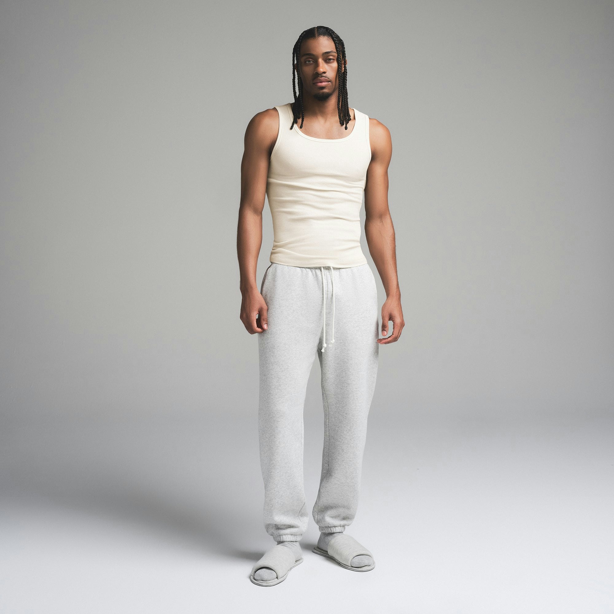 SKIMS COTTON MENS RIB TANK 3-PACK | ECRU MULTI ON A MODEL FRONT VIEW | FOCUS: 0.0, 1.0, 0.9