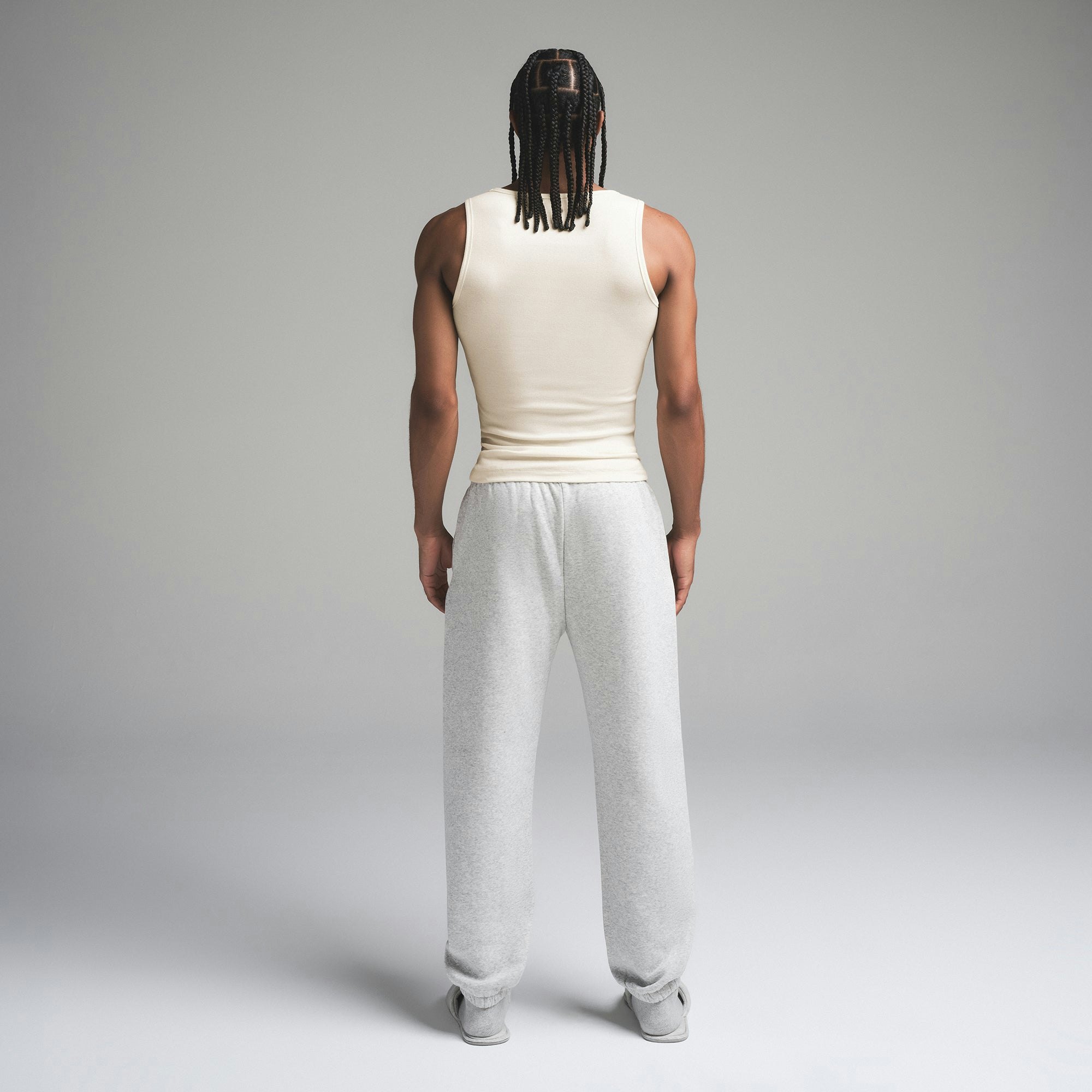 SKIMS COTTON MENS RIB TANK 3-PACK | ECRU MULTI ON A MODEL SIDE VIEW | FOCUS: 0.0, 1.0, 0.9