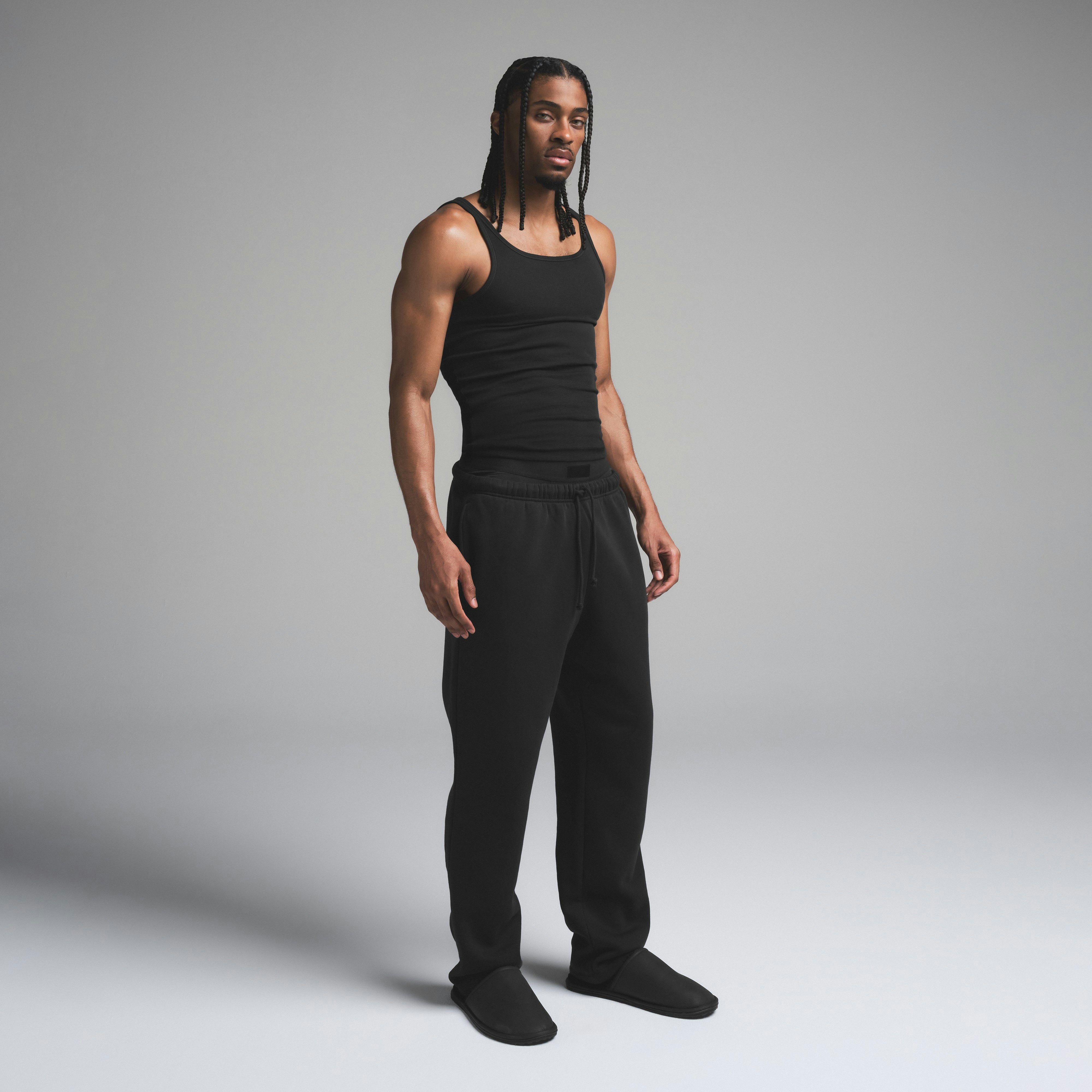SKIMS COTTON MENS RIB TANK 3-PACK | ONYX ON A MODEL SIDE VIEW | FOCUS: 0.0, 1.0, 0.9