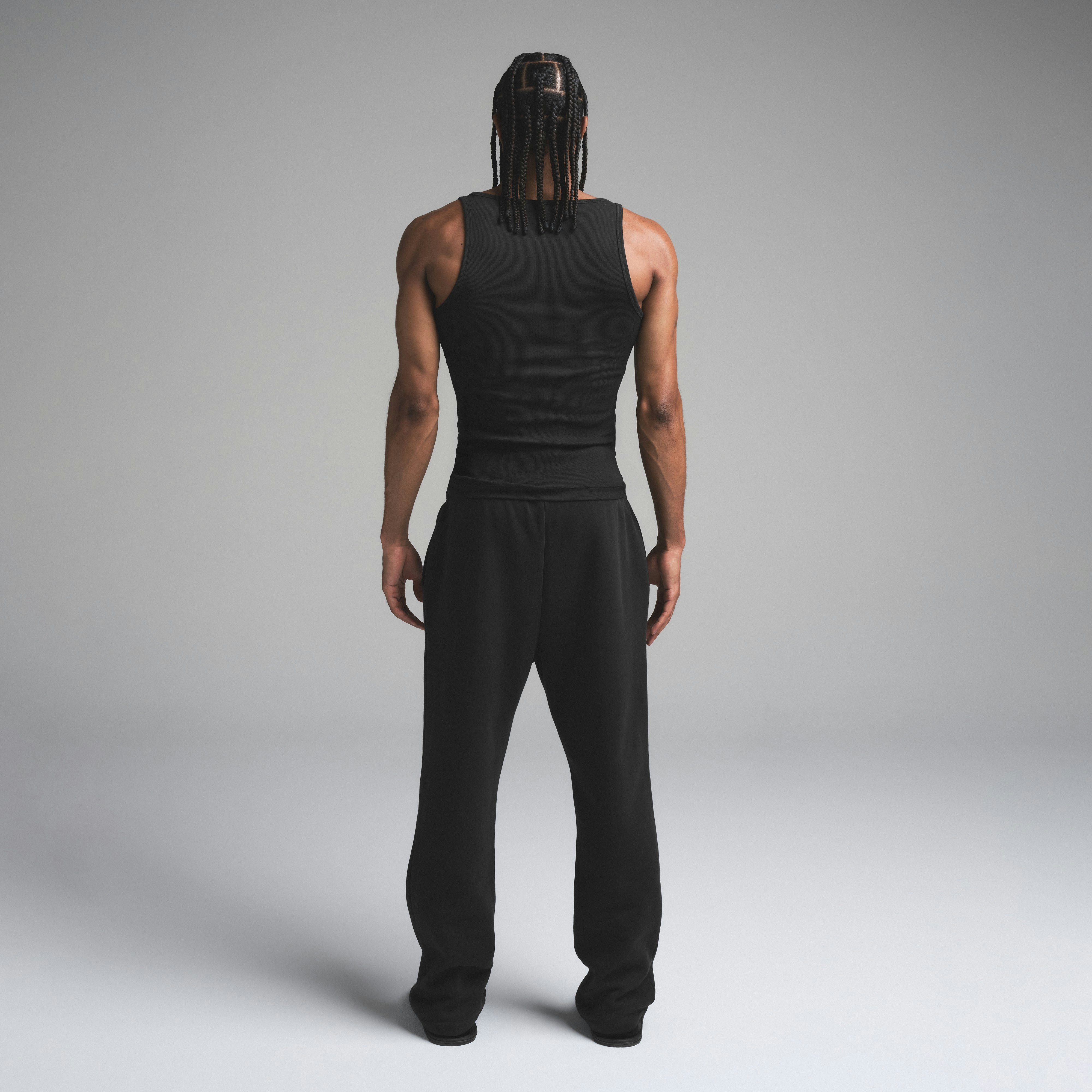 SKIMS COTTON MENS RIB TANK 3-PACK | ONYX ON A MODEL SIDE VIEW | FOCUS: 0.0, 1.0, 0.9