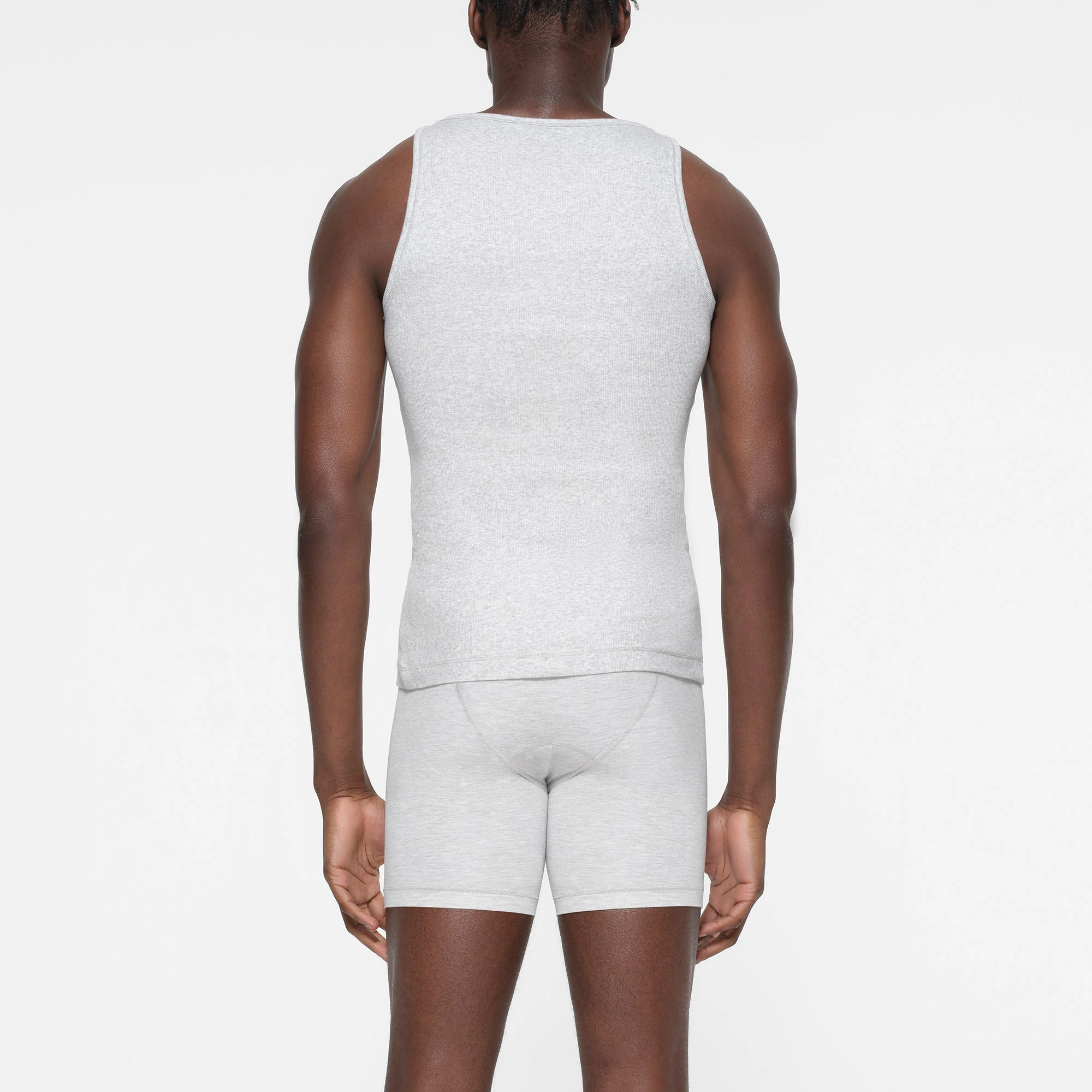 SKIMS COTTON MENS RIB TANK 3-PACK | LIGHT HEATHER GREY ON A MODEL BACK VIEW