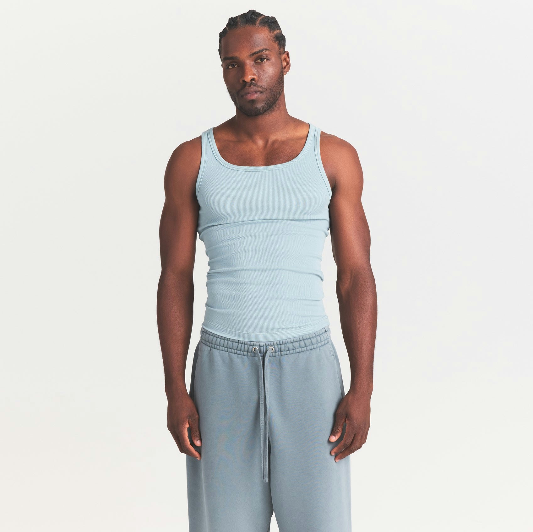 SKIMS COTTON MENS RIB TANK 3-PACK | VERDANT DARK SEPIA MULTI ON A MODEL SIDE VIEW @ | FOCUS: 0.0, 1.0, 0.9