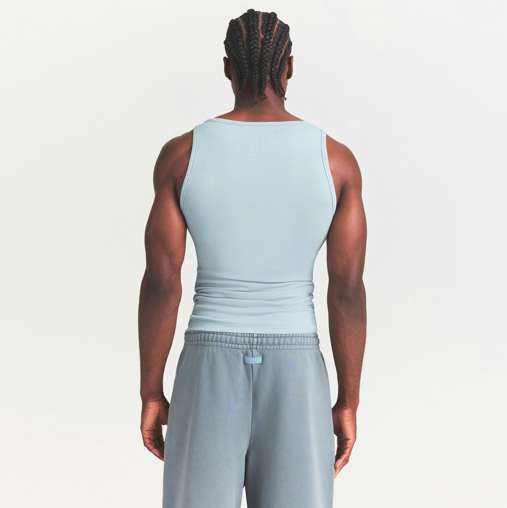 SKIMS COTTON MENS RIB TANK 3-PACK | VERDANT DARK SEPIA MULTI ON A MODEL SIDE VIEW @ | FOCUS: 0.0, 1.0, 0.9