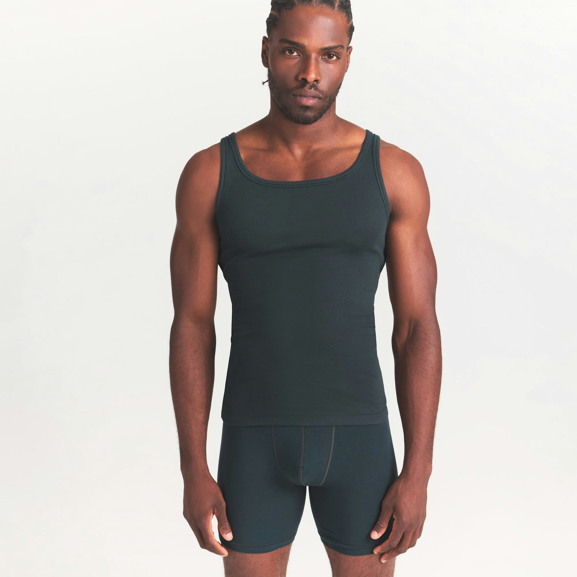 SKIMS COTTON MENS RIB TANK 3-PACK | VERDANT DARK SEPIA MULTI ON A MODEL SIDE VIEW @ | FOCUS: 0.0, 1.0, 0.9