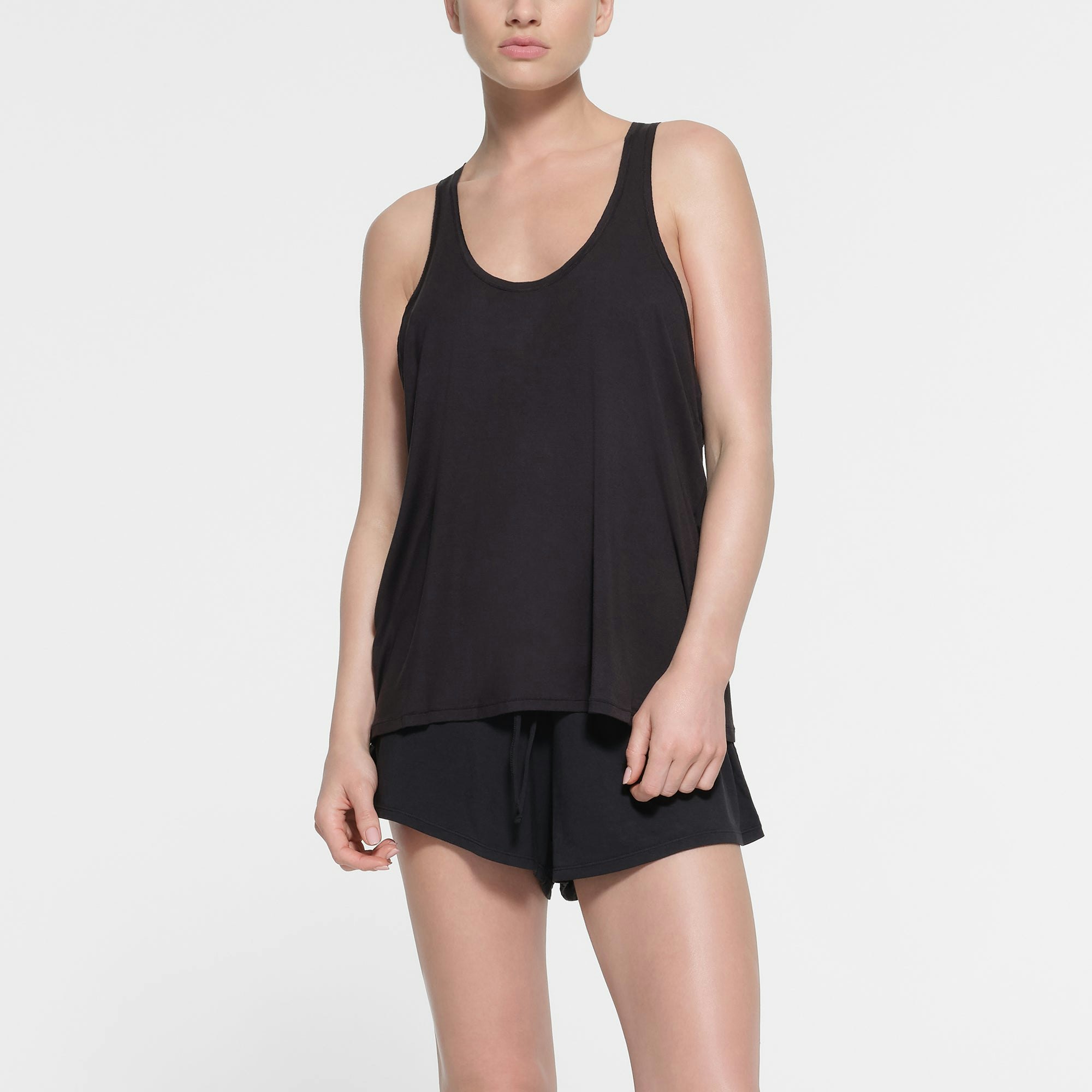 SKIMS SLEEP LOOSE TANK | ONYX ON A MODEL FRONT VIEW