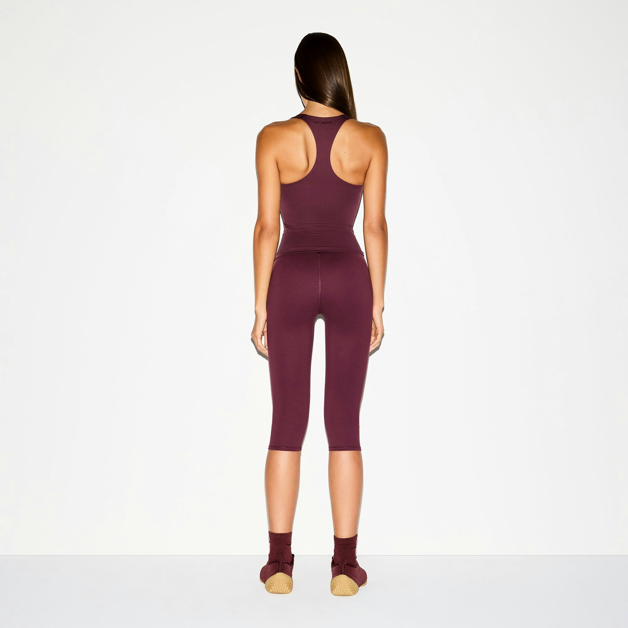 NikeSKIMS MATTE RACER BACK TANK | CURRANT ON A MODEL BACK VIEW @ | FOCUS: 0.0, 1.0, 0.9