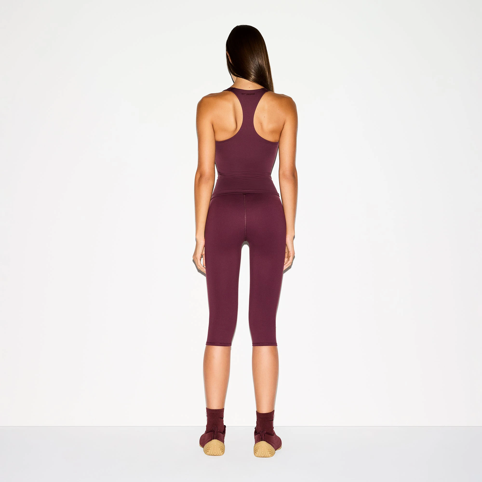 NikeSKIMS MATTE RACER BACK TANK | CURRANT ON A MODEL BACK VIEW @ | FOCUS: 0.0, 1.0, 0.9