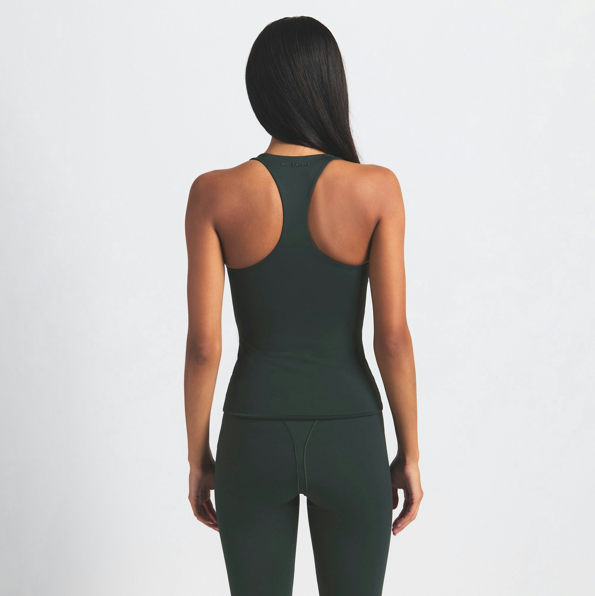 NikeSKIMS MATTE RACER BACK TANK | DARK TEAL ON A MODEL SIDE VIEW @ | FOCUS: 0.0, 1.0, 0.9