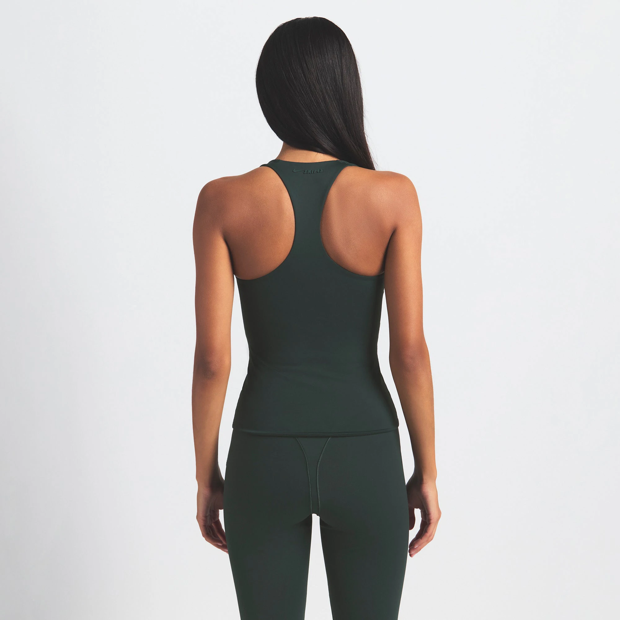 NikeSKIMS MATTE RACER BACK TANK | DARK TEAL ON A MODEL SIDE VIEW @ | FOCUS: 0.0, 1.0, 0.9