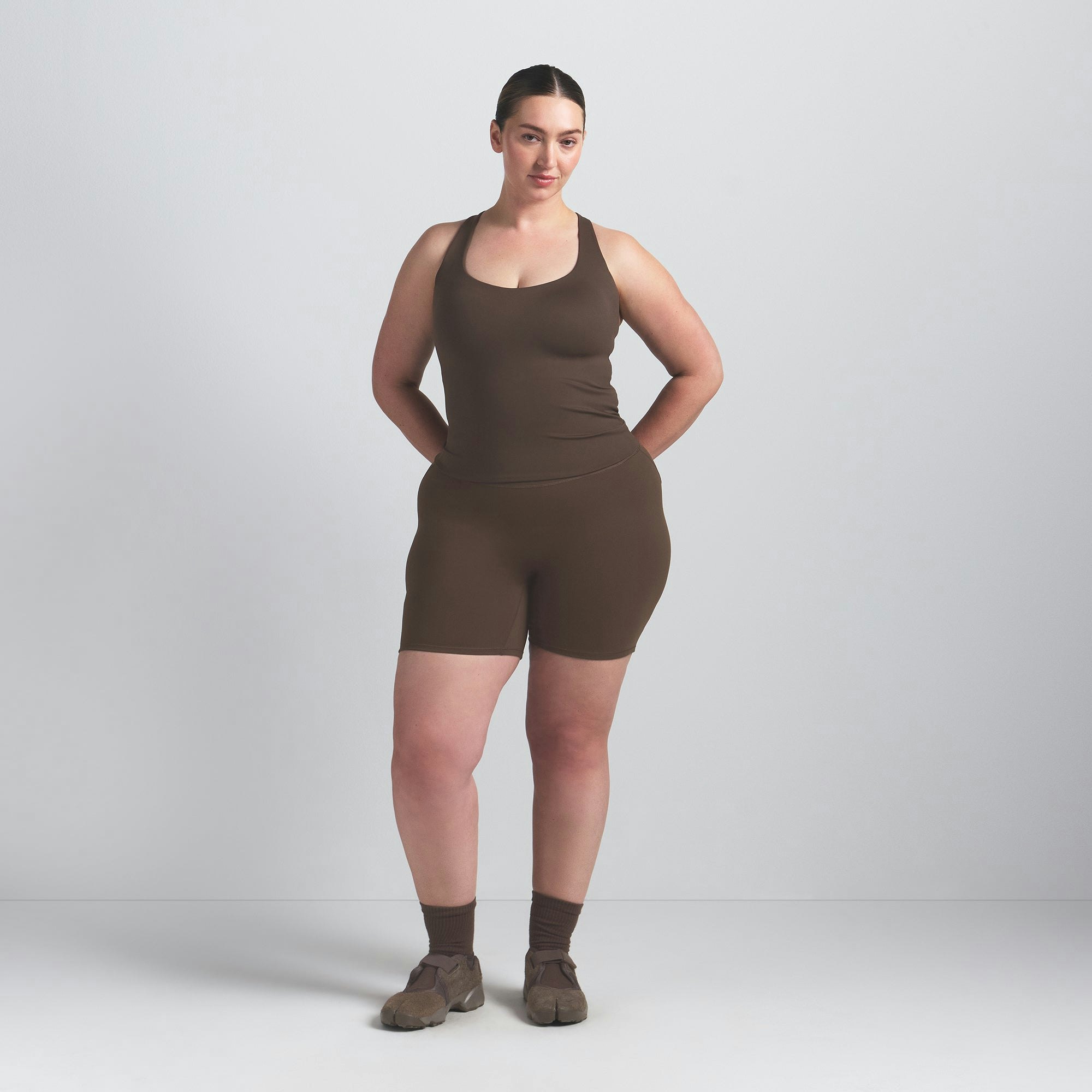 NikeSKIMS MATTE RACER BACK TANK | DARK SEPIA ON A MODEL FRONT VIEW