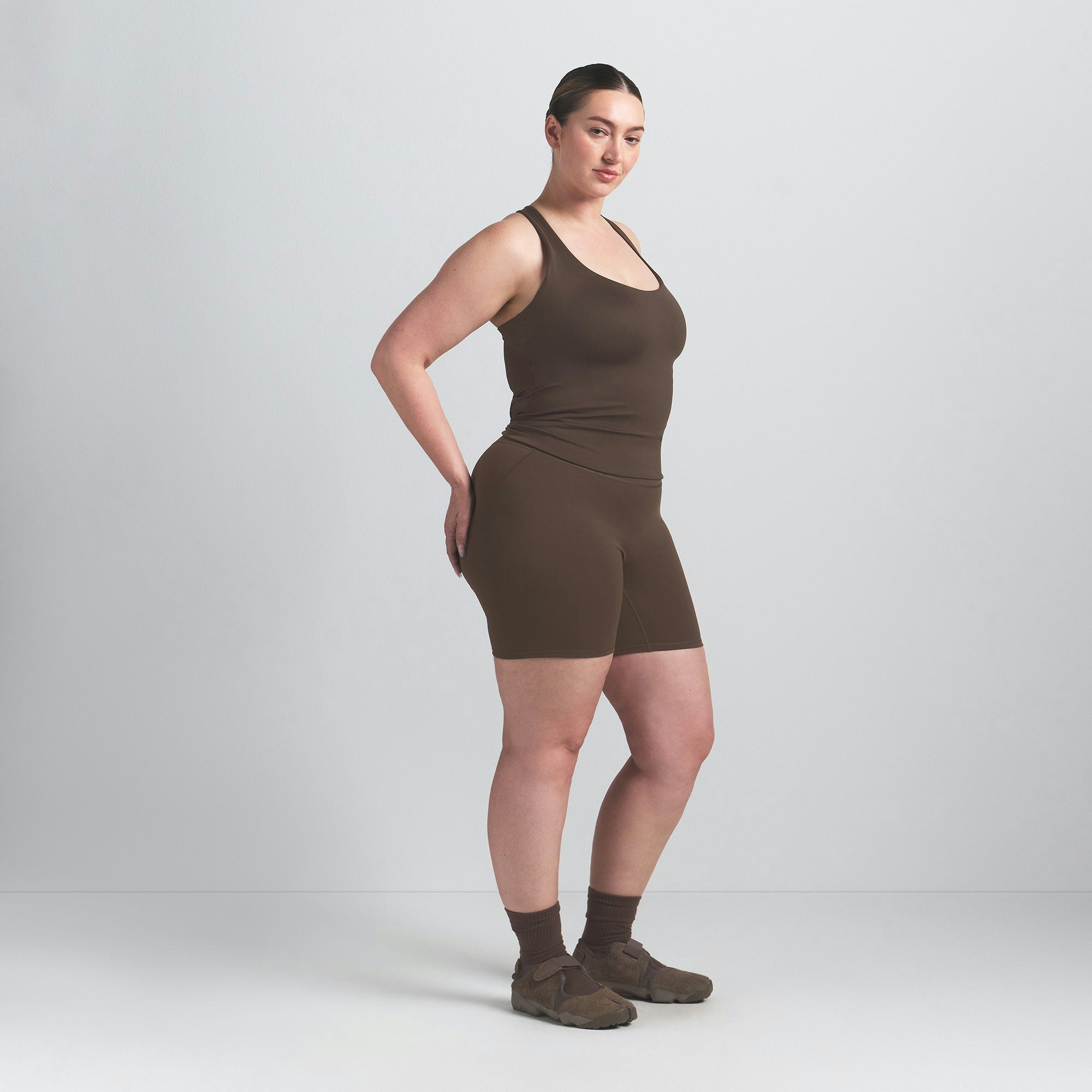 NikeSKIMS MATTE RACER BACK TANK | DARK SEPIA ON A MODEL SIDE VIEW