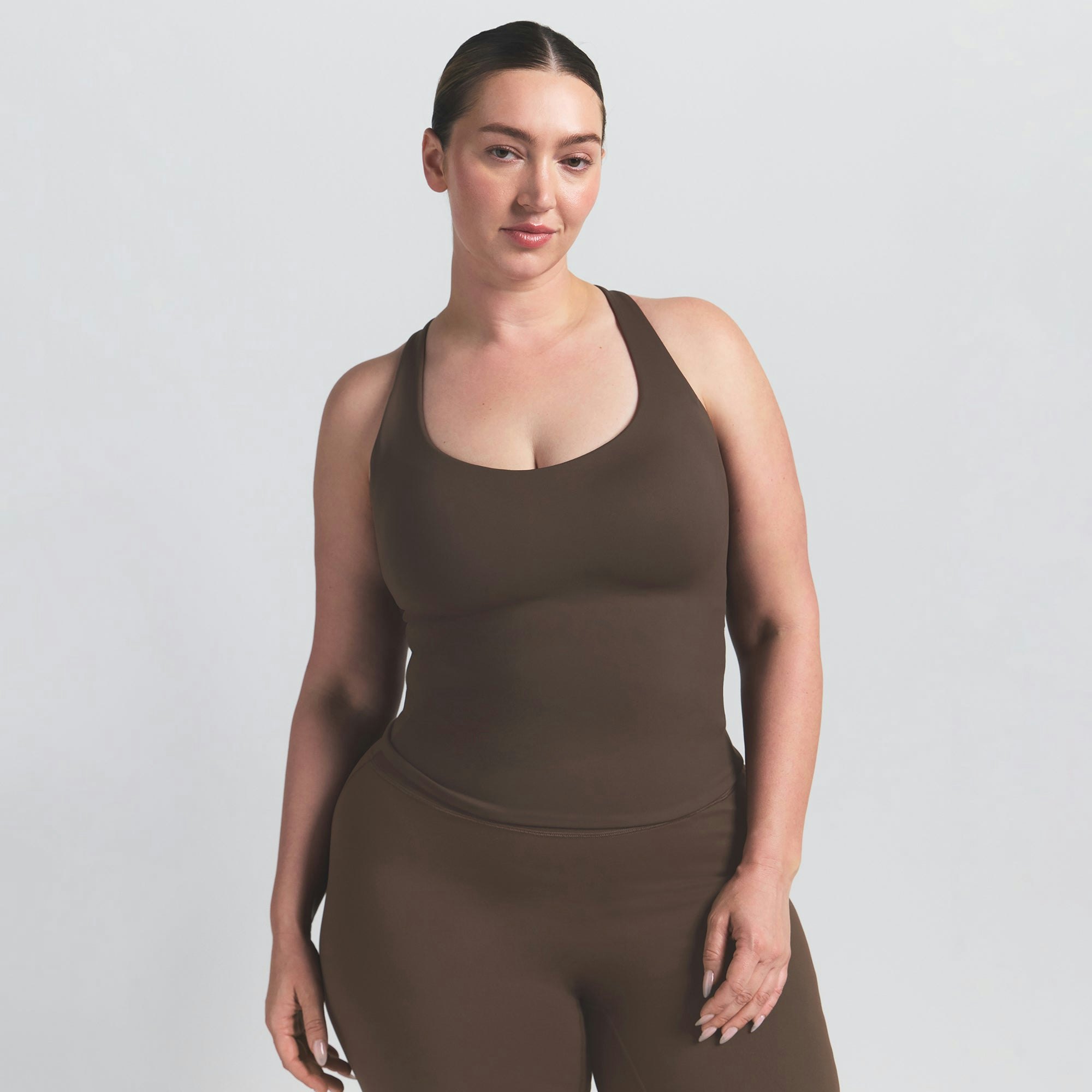 NikeSKIMS MATTE RACER BACK TANK | DARK SEPIA ON A MODEL FRONT VIEW