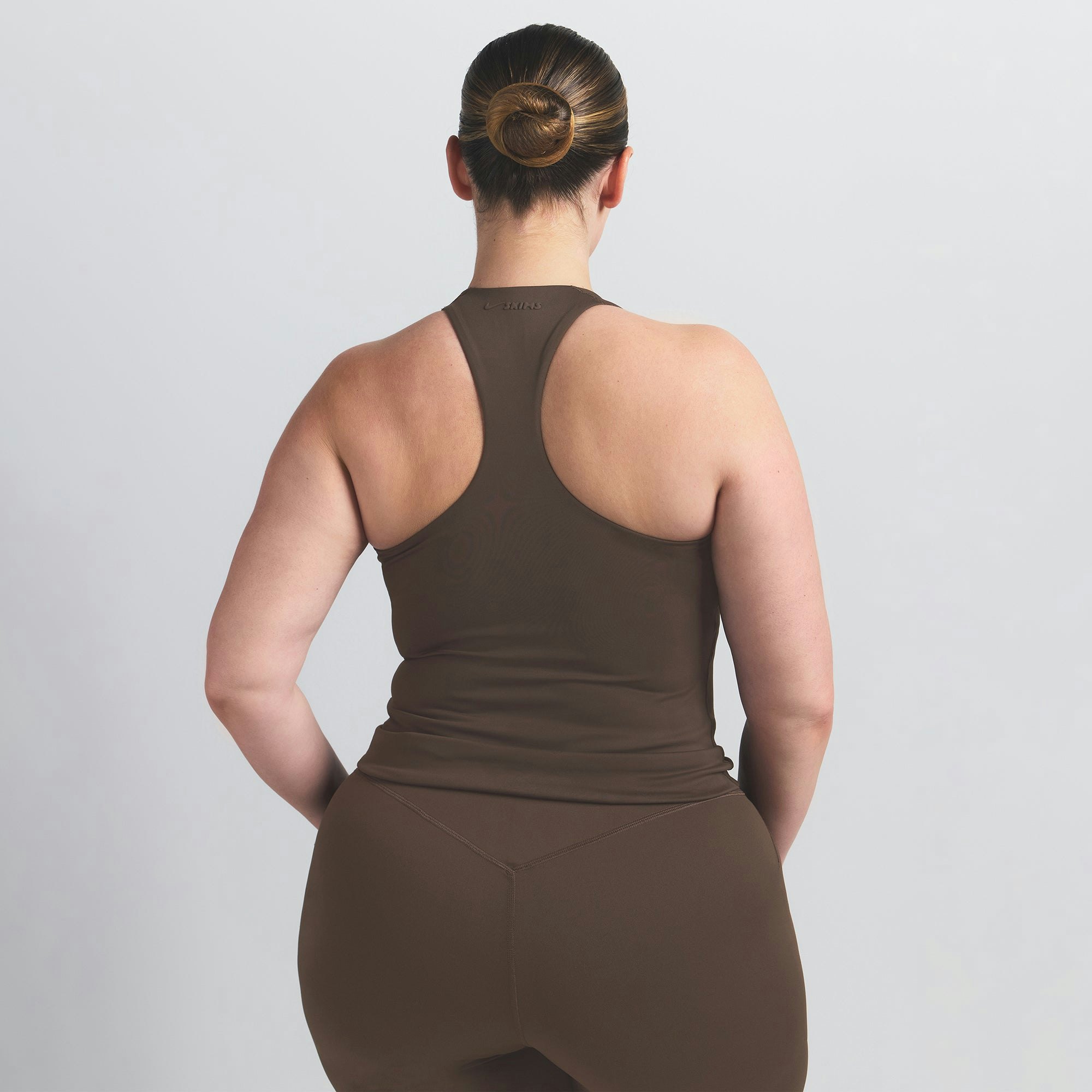 NikeSKIMS MATTE RACER BACK TANK | DARK SEPIA ON A MODEL BACK VIEW