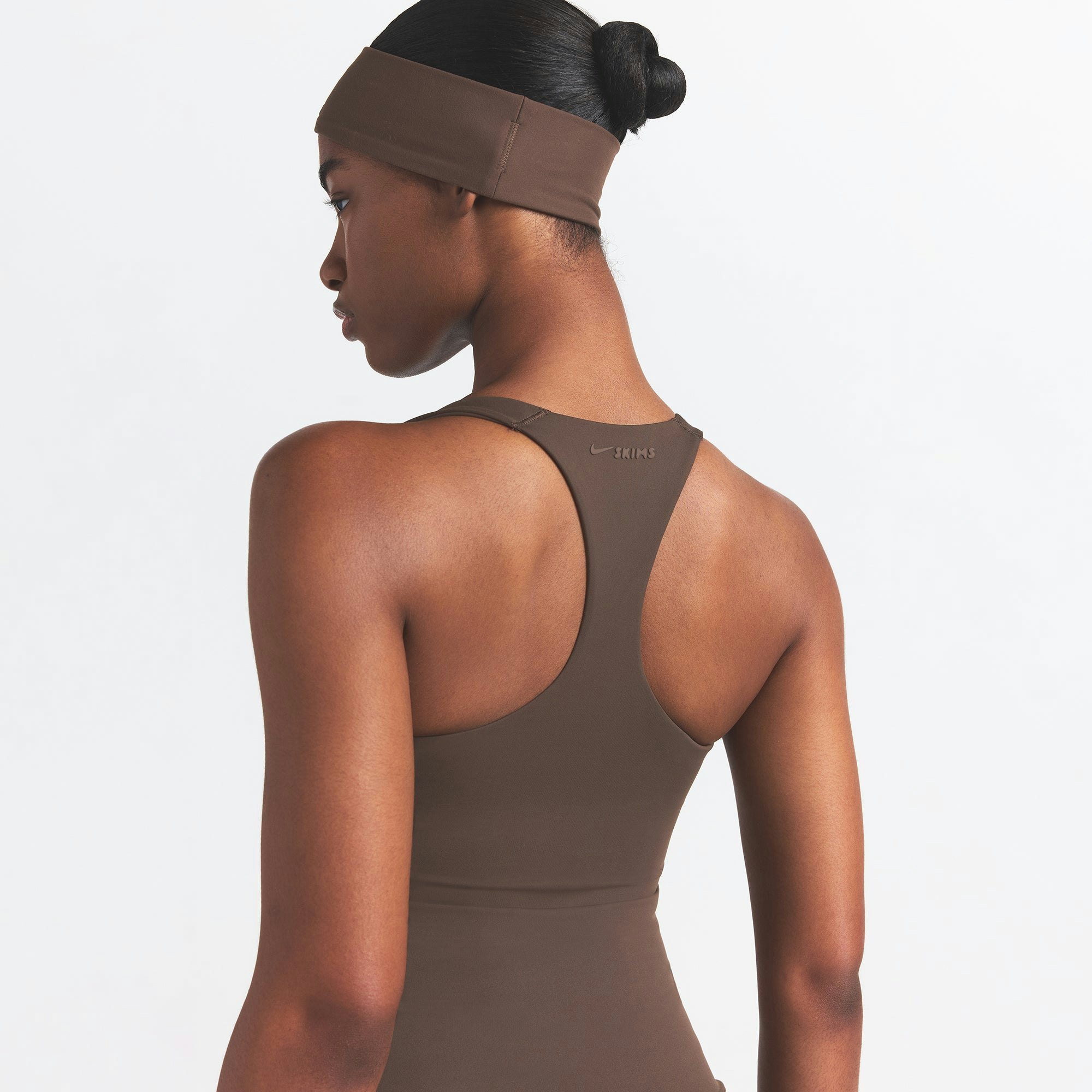 NikeSKIMS MATTE RACER BACK TANK | DARK SEPIA ON A MODEL BACK VIEW