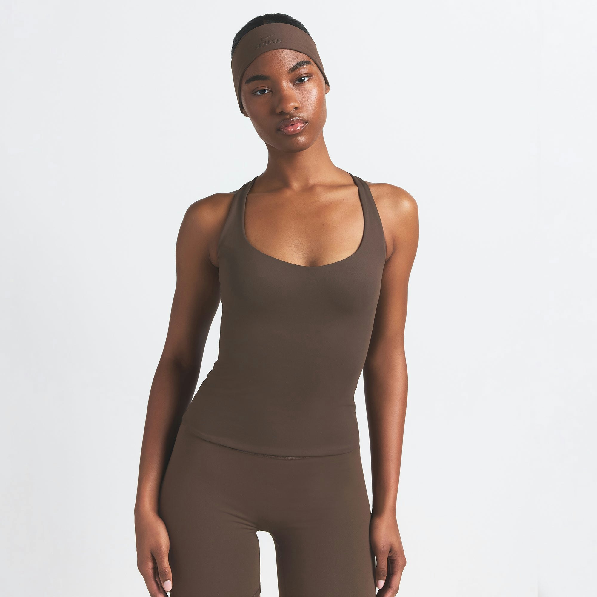 NikeSKIMS MATTE RACER BACK TANK | DARK SEPIA ON A MODEL FRONT VIEW
