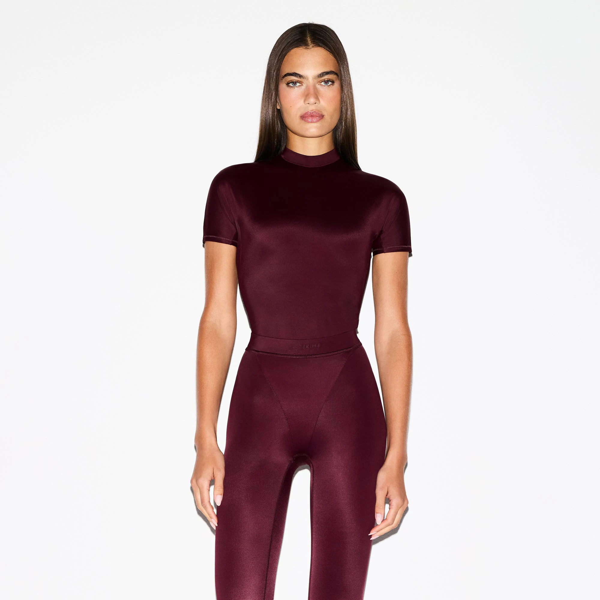 NikeSKIMS SHINE SHORT SLEEVE MOCK NECK TOP | CURRANT ON A MODEL SIDE VIEW @ | FOCUS: 0.0, 1.0, 0.9