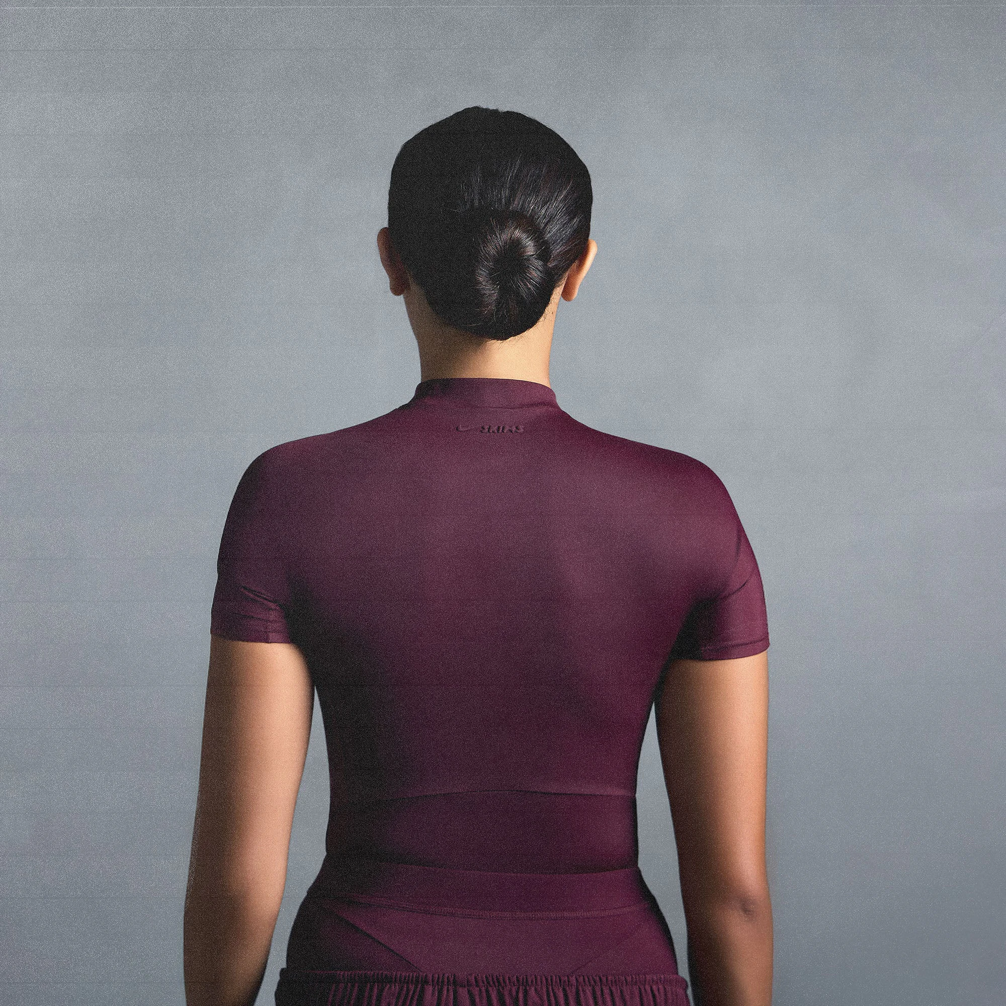 NikeSKIMS SHINE SHORT SLEEVE MOCK NECK TOP | CURRANT ON A MODEL SIDE VIEW @ | FOCUS: 0.0, 1.0, 0.9