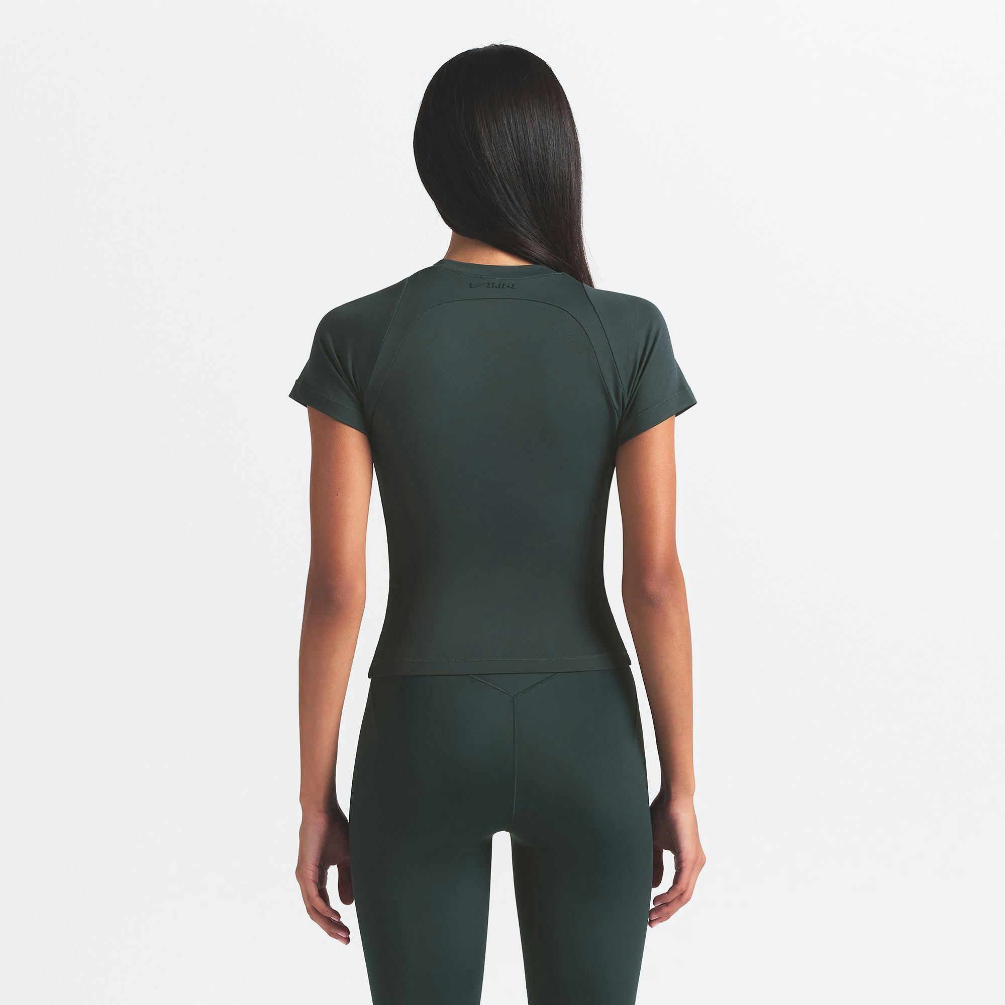 NikeSKIMS AIRY BABY TEE | DARK TEAL ON A MODEL SIDE VIEW @ | FOCUS: 0.0, 1.0, 0.9