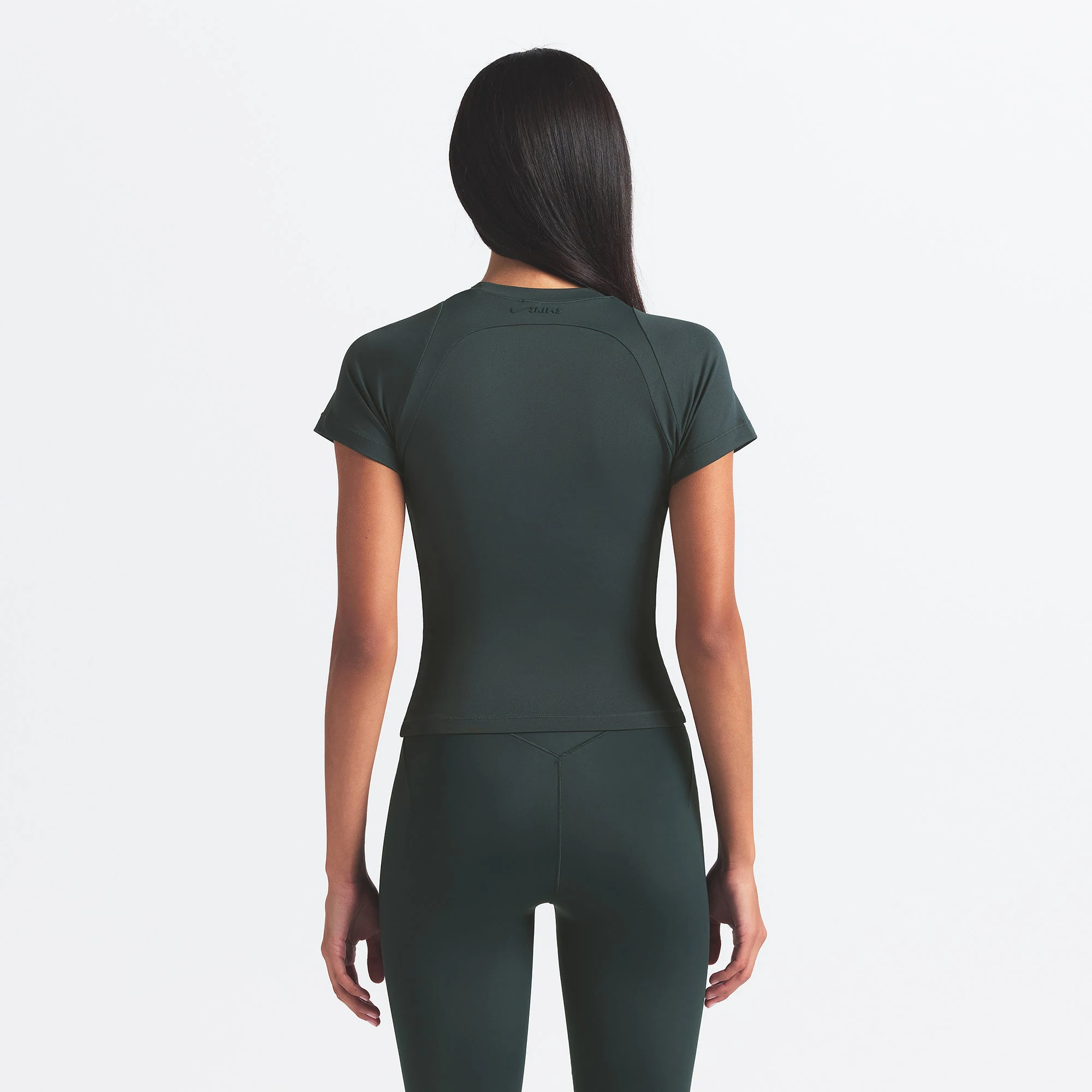 NikeSKIMS AIRY BABY TEE | DARK TEAL ON A MODEL SIDE VIEW @ | FOCUS: 0.0, 1.0, 0.9