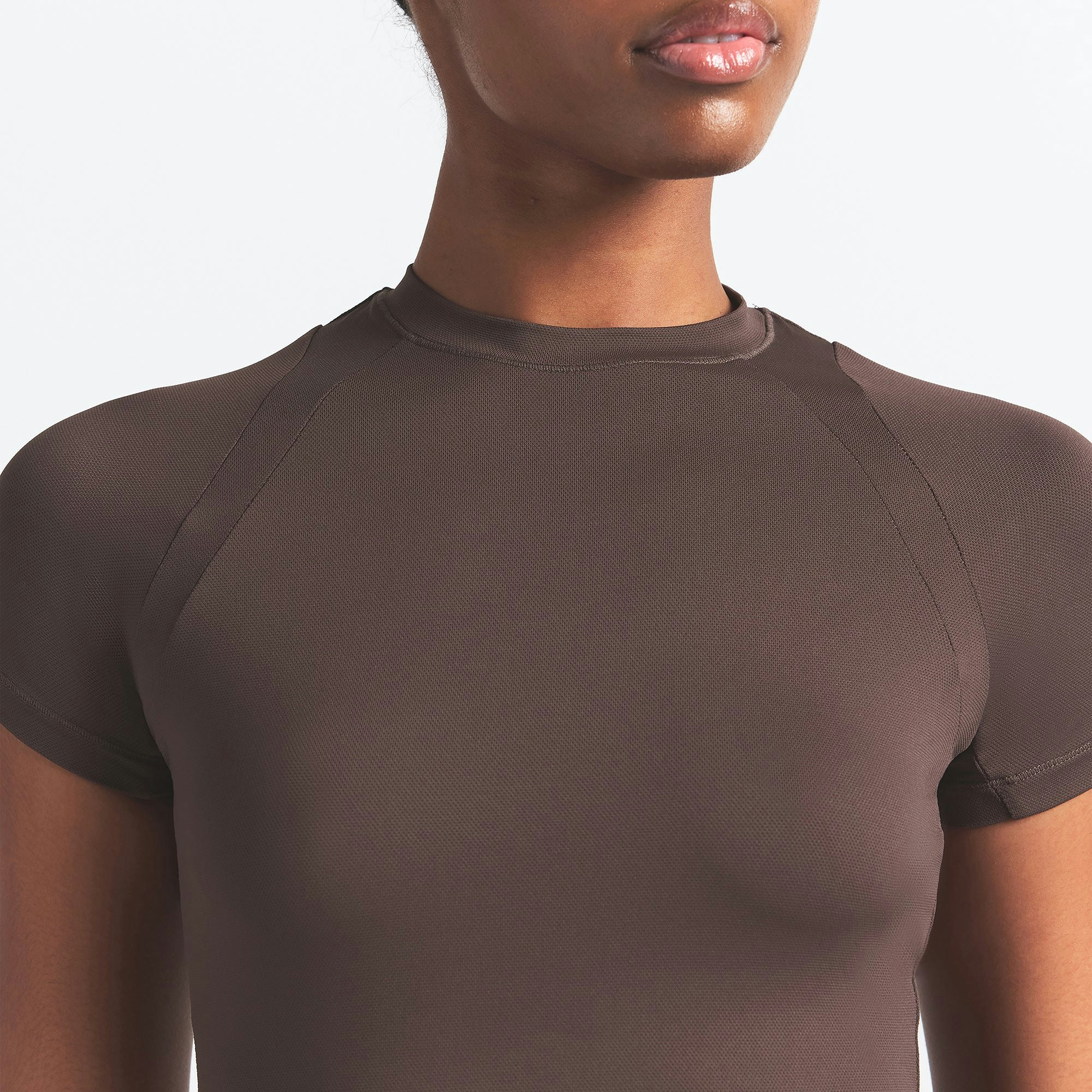 NikeSKIMS AIRY BABY TEE | DARK SEPIA ON A MODEL SIDE VIEW @ | FOCUS: 0.9, 0.1, 0.7