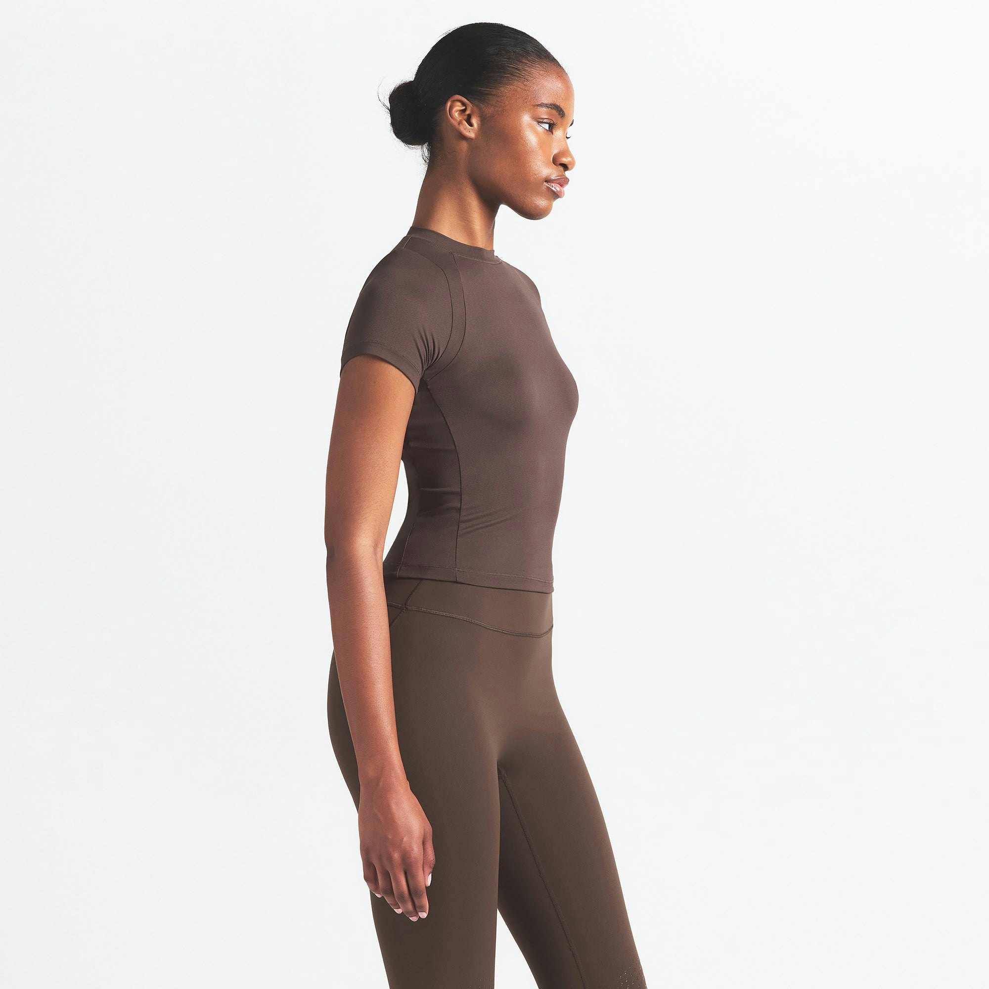 NikeSKIMS AIRY BABY TEE | DARK SEPIA ON A MODEL SIDE VIEW @ | FOCUS: 0.9, 0.1, 0.7