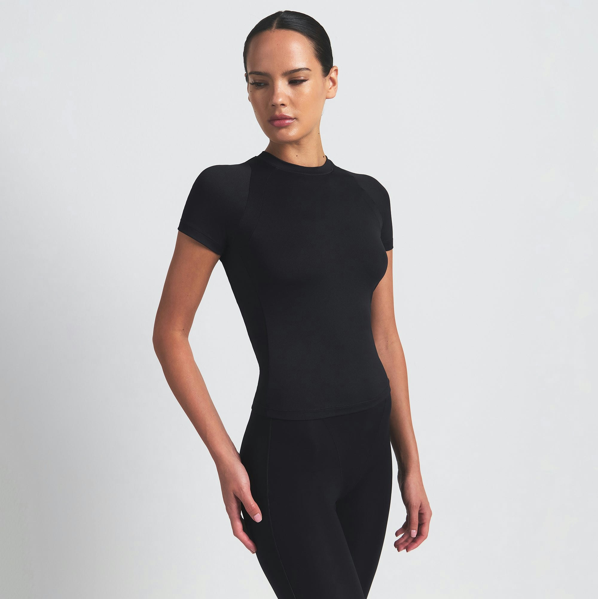 NikeSKIMS AIRY BABY TEE | OBSIDIAN ON A MODEL SIDE VIEW @ | FOCUS: 0.9, 0.1, 0.7