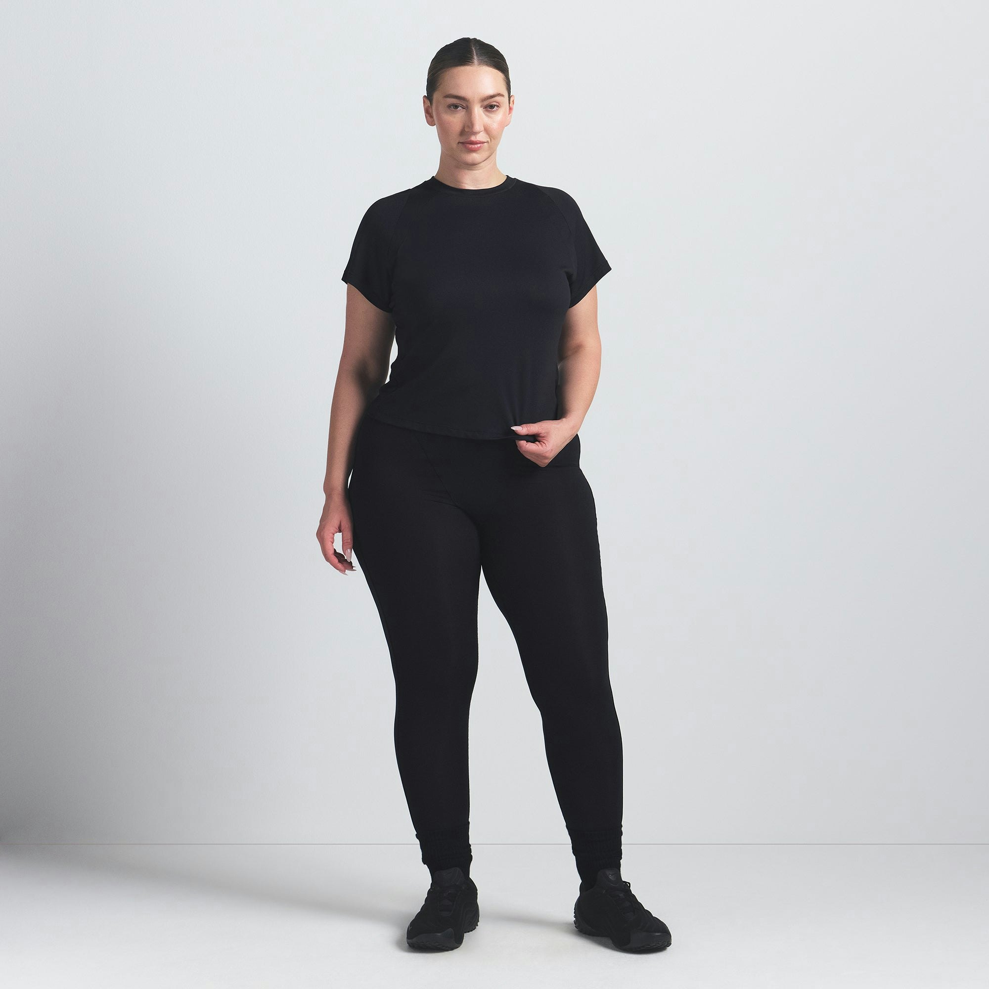 NikeSKIMS AIRY BABY TEE | OBSIDIAN ON A MODEL FRONT VIEW @ | FOCUS: 0.9, 0.1, 0.7