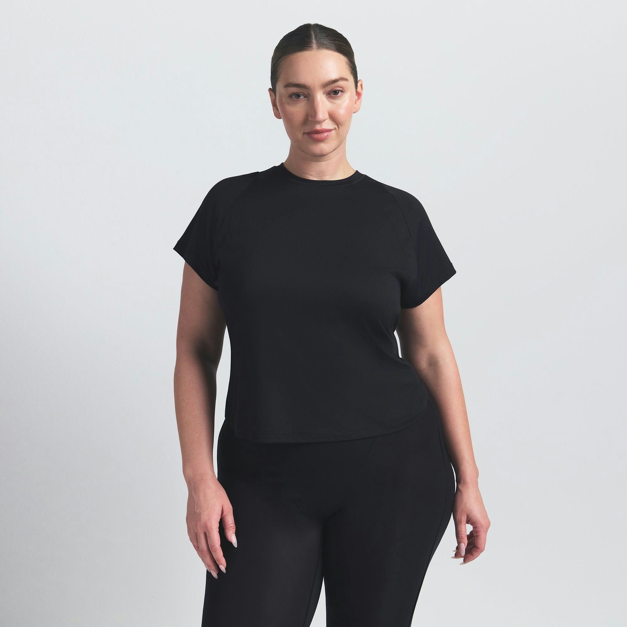 NikeSKIMS AIRY BABY TEE | OBSIDIAN ON A MODEL SIDE VIEW @ | FOCUS: 0.9, 0.1, 0.7