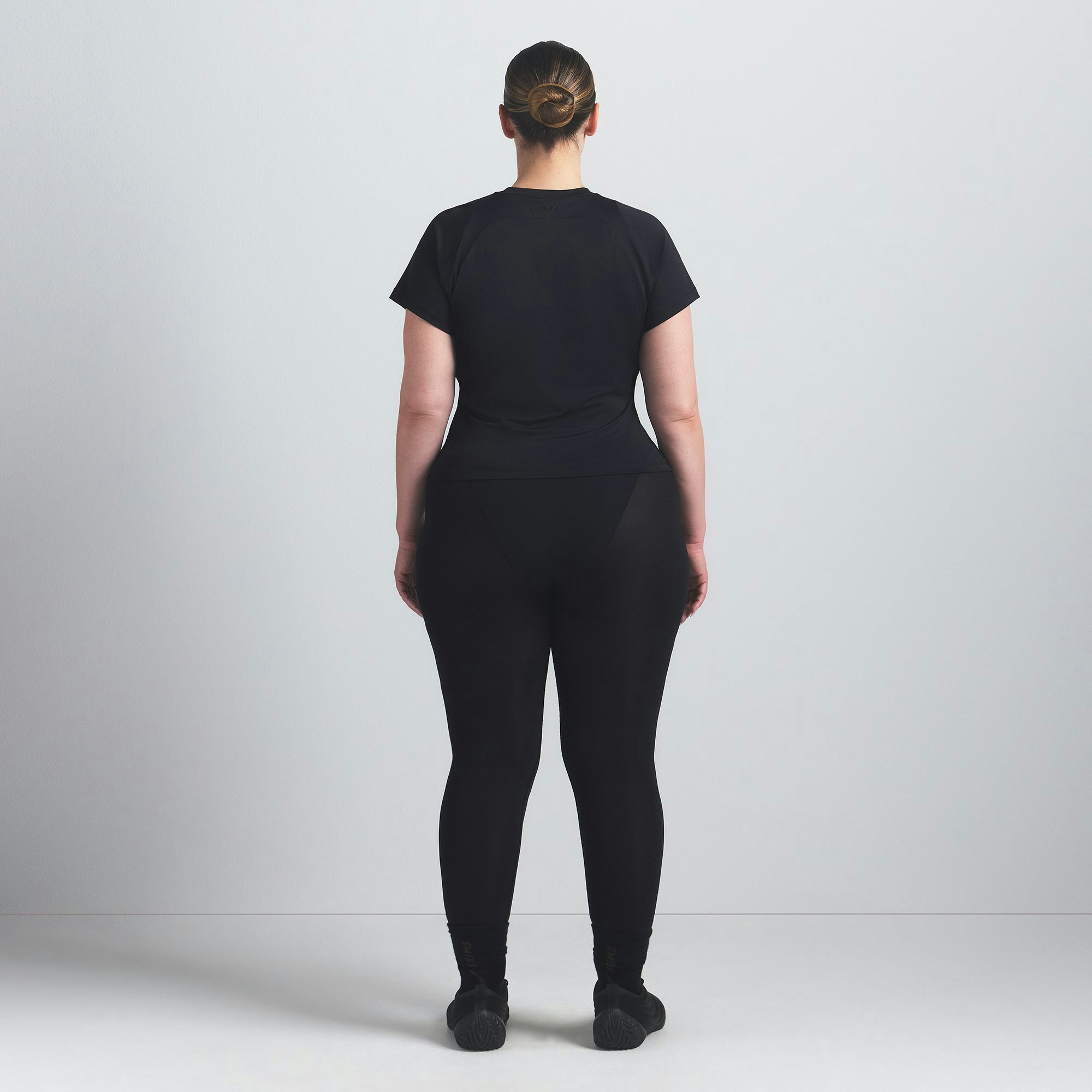 NikeSKIMS AIRY BABY TEE | OBSIDIAN ON A MODEL FRONT VIEW @ | FOCUS: 0.9, 0.1, 0.7