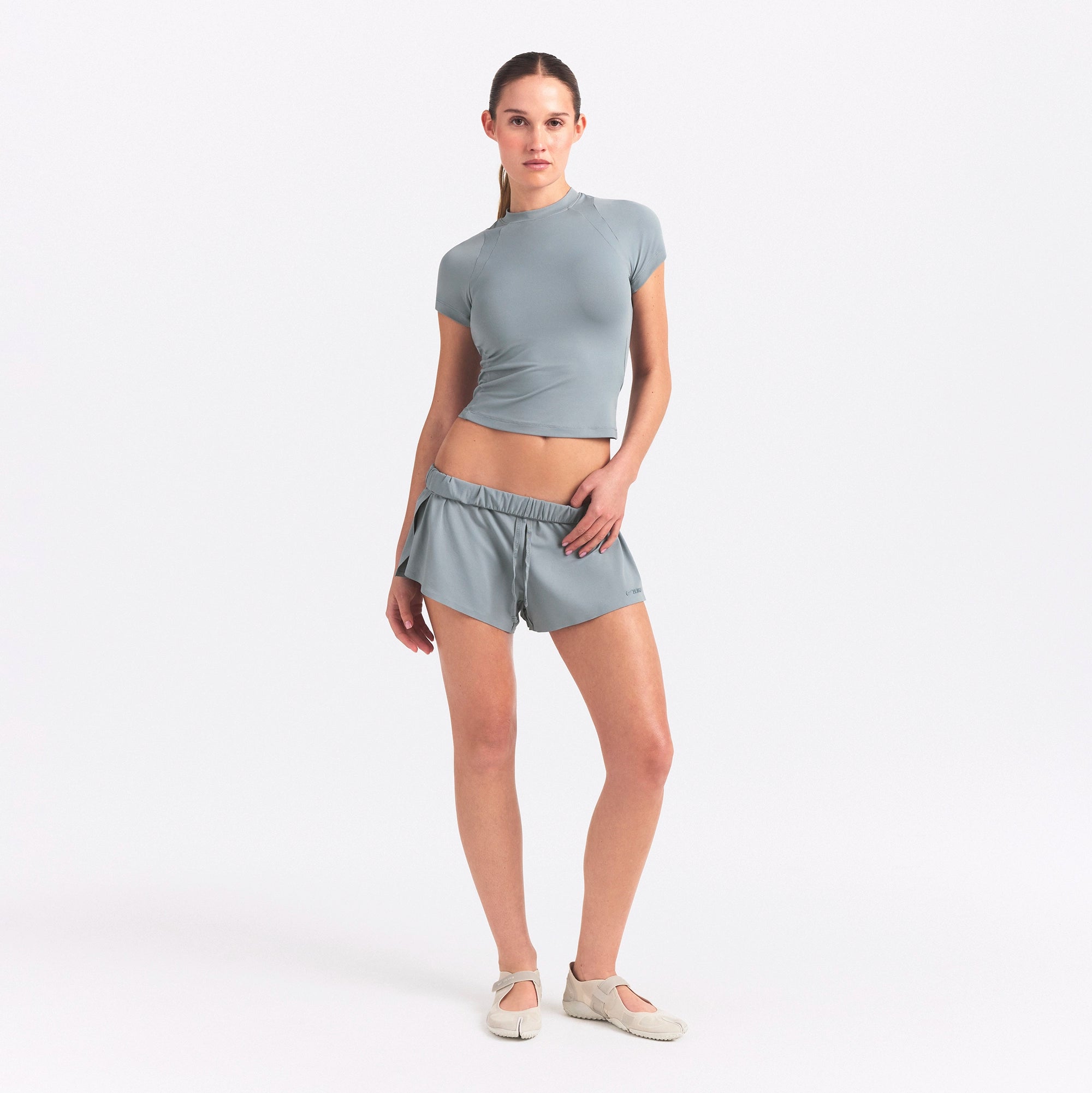 NikeSKIMS AIRY BABY TEE | WASHED PACIFIC ON A MODEL FRONT VIEW @ | FOCUS: 0.0, 1.0, 0.9