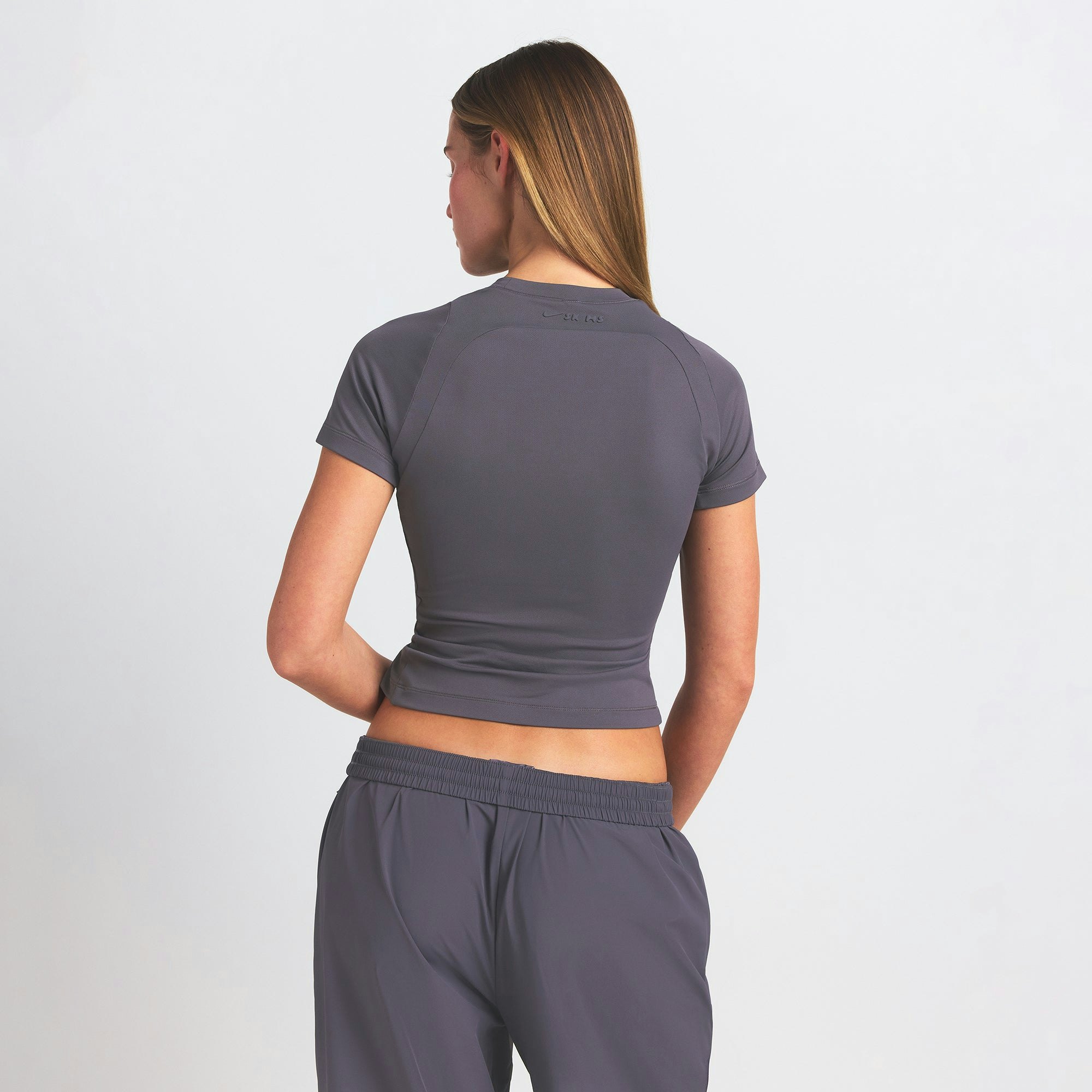 NikeSKIMS AIRY BABY TEE | RAVEN ON A MODEL SIDE VIEW @ | FOCUS: 0.0, 1.0, 0.9