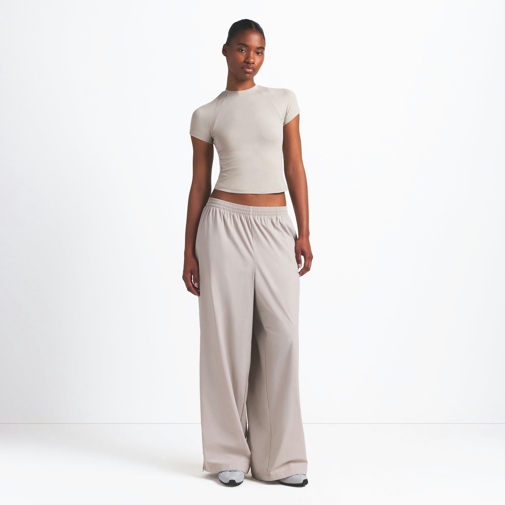 NikeSKIMS AIRY BABY TEE | STONE ON A MODEL FRONT VIEW @ | FOCUS: 0.0, 1.0, 0.9