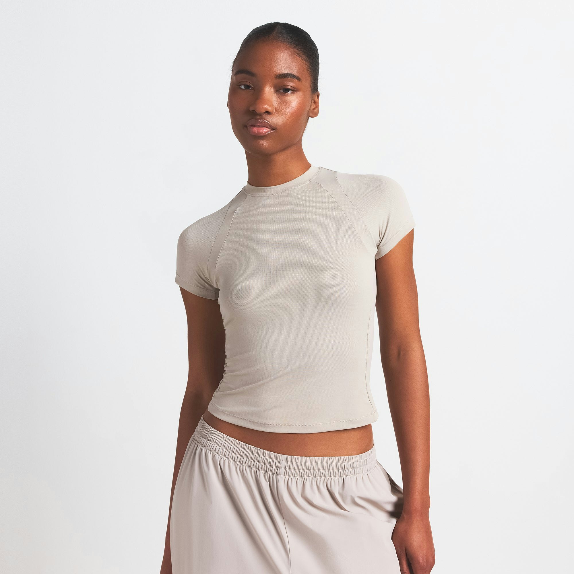 NikeSKIMS AIRY BABY TEE | STONE ON A MODEL SIDE VIEW @ | FOCUS: 0.0, 1.0, 0.9