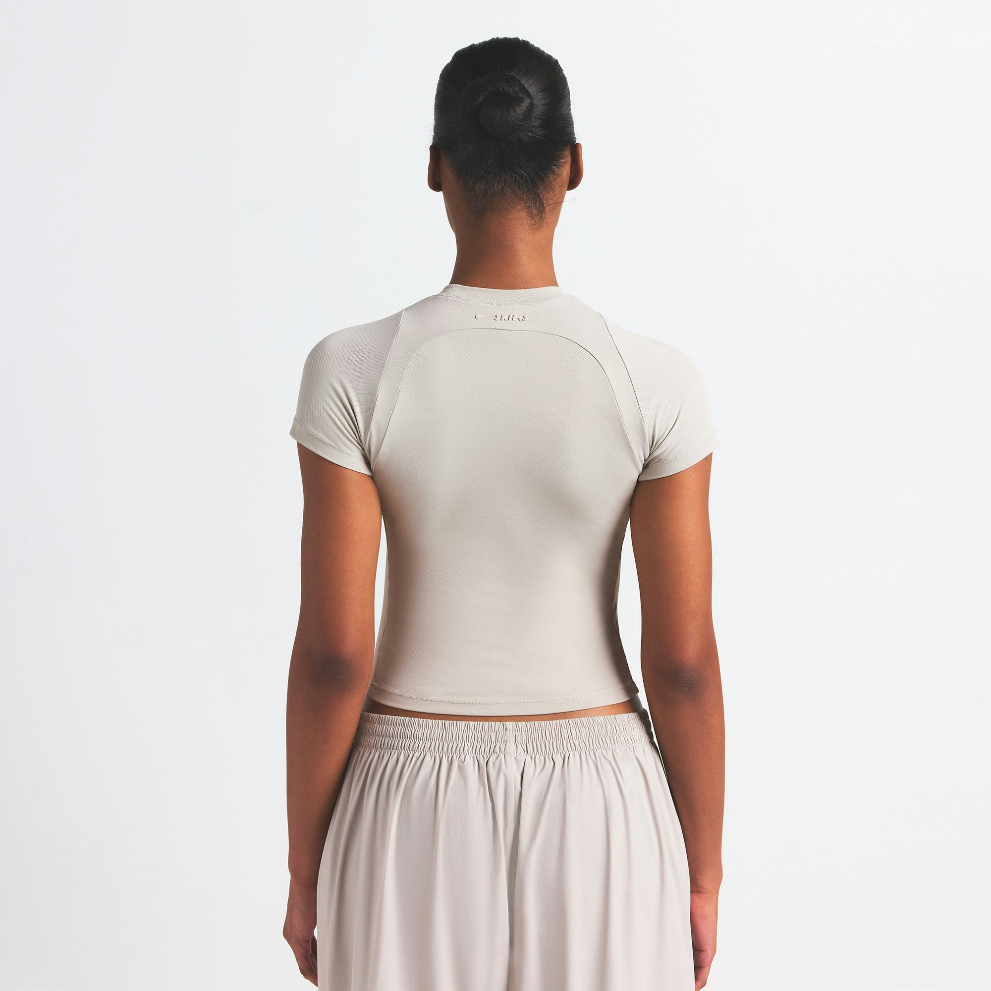 NikeSKIMS AIRY BABY TEE | STONE ON A MODEL SIDE VIEW @ | FOCUS: 0.0, 1.0, 0.9