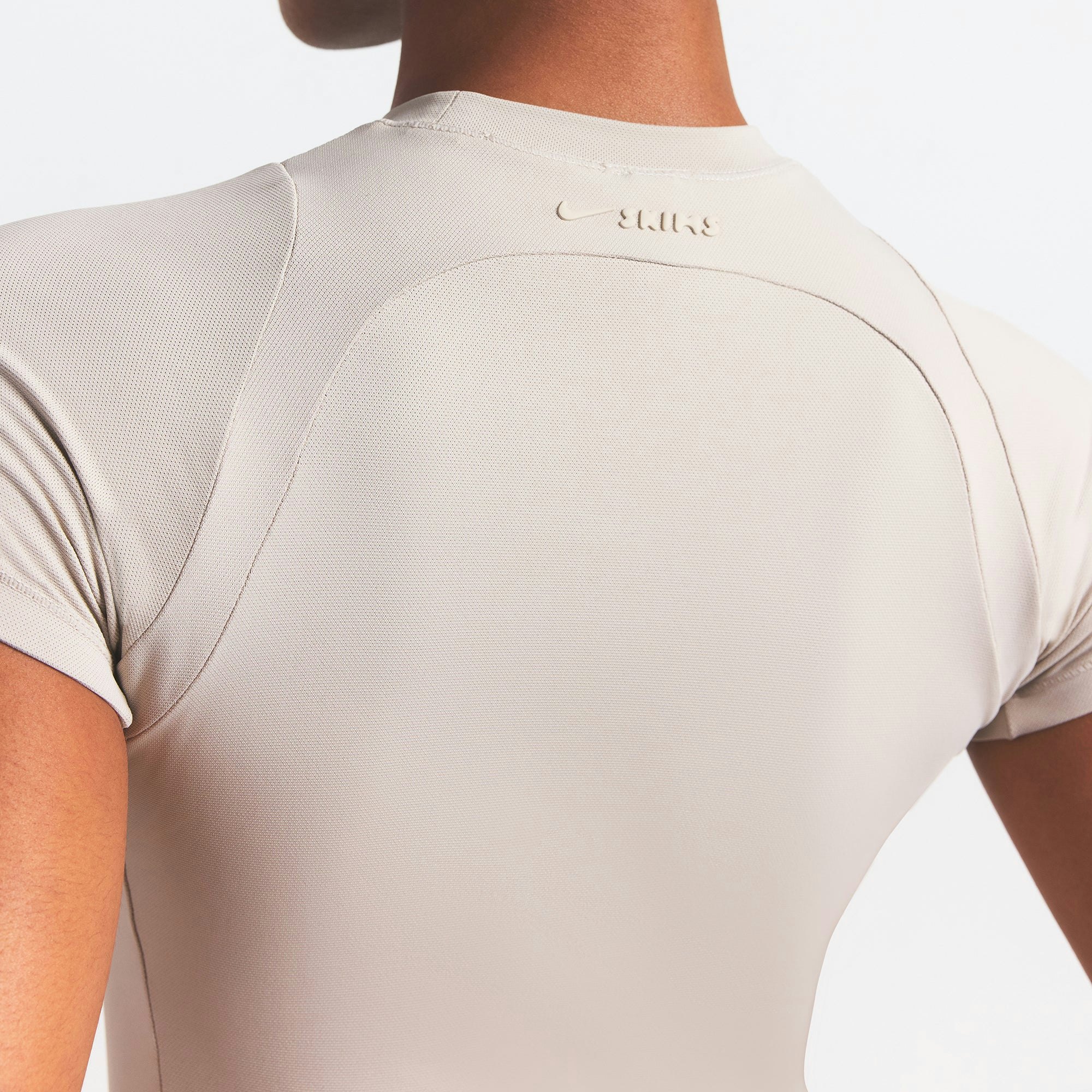 NikeSKIMS AIRY BABY TEE | STONE ON A MODEL SIDE VIEW @ | FOCUS: 0.0, 1.0, 0.9