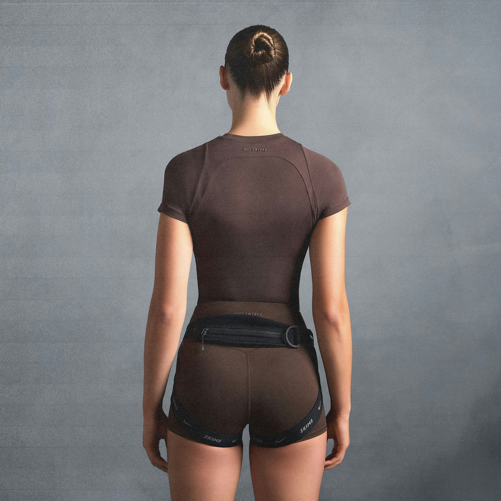 NikeSKIMS AIRY BABY TEE | DARK SEPIA ON A MODEL SIDE VIEW @ | FOCUS: 0.0, 1.0, 0.9