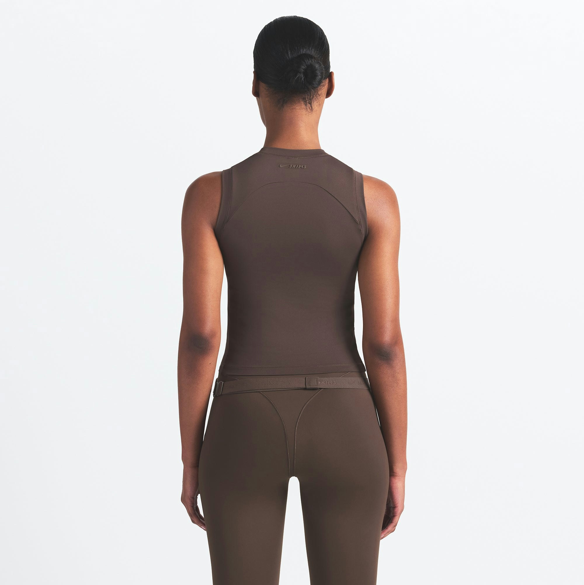 NikeSKIMS AIRY MUSCLE TEE | DARK SEPIA ON A MODEL SIDE VIEW @ | FOCUS: 0.0, 1.0, 0.9