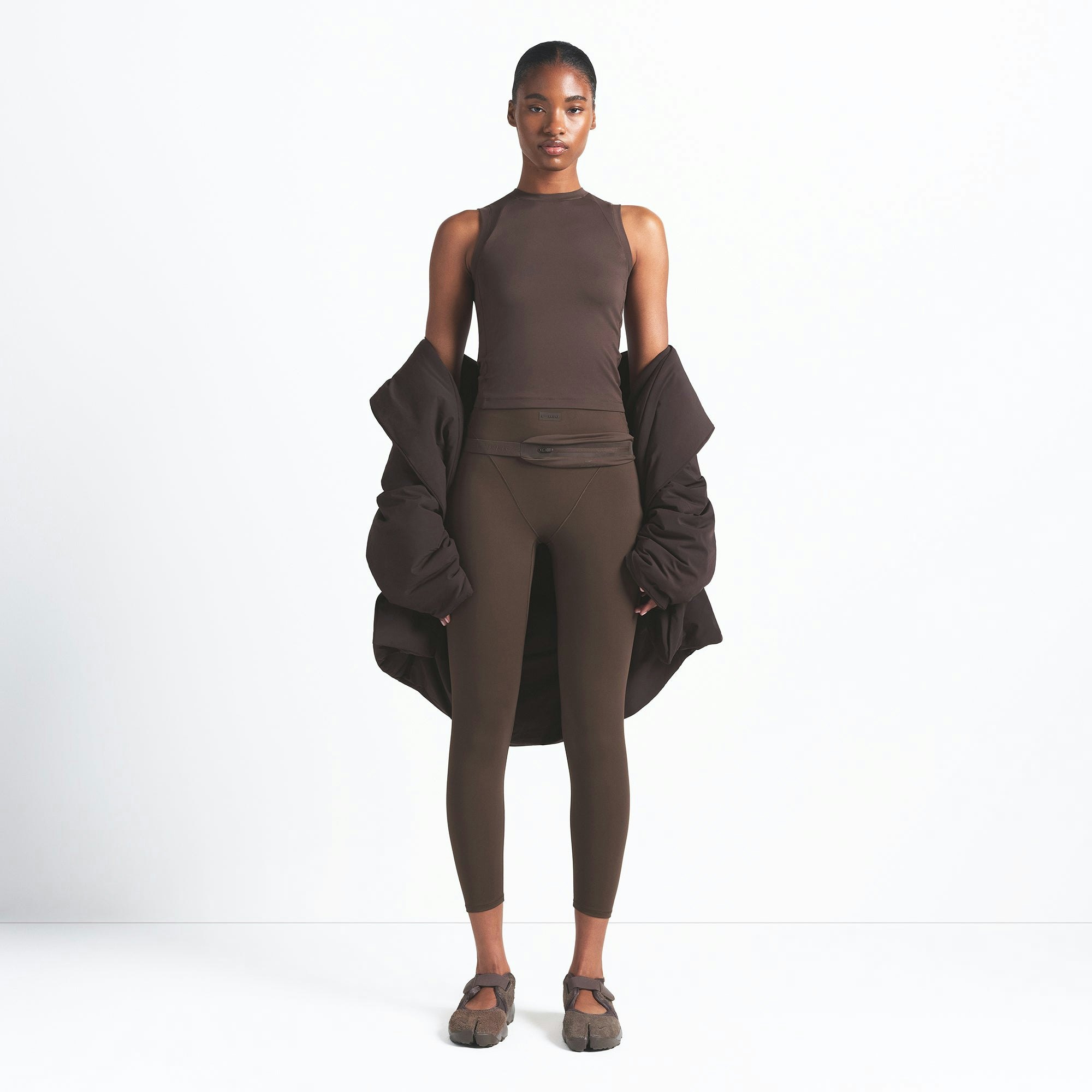 NikeSKIMS AIRY MUSCLE TEE | DARK SEPIA ON A MODEL FRONT VIEW @ | FOCUS: 0.0, 1.0, 0.9